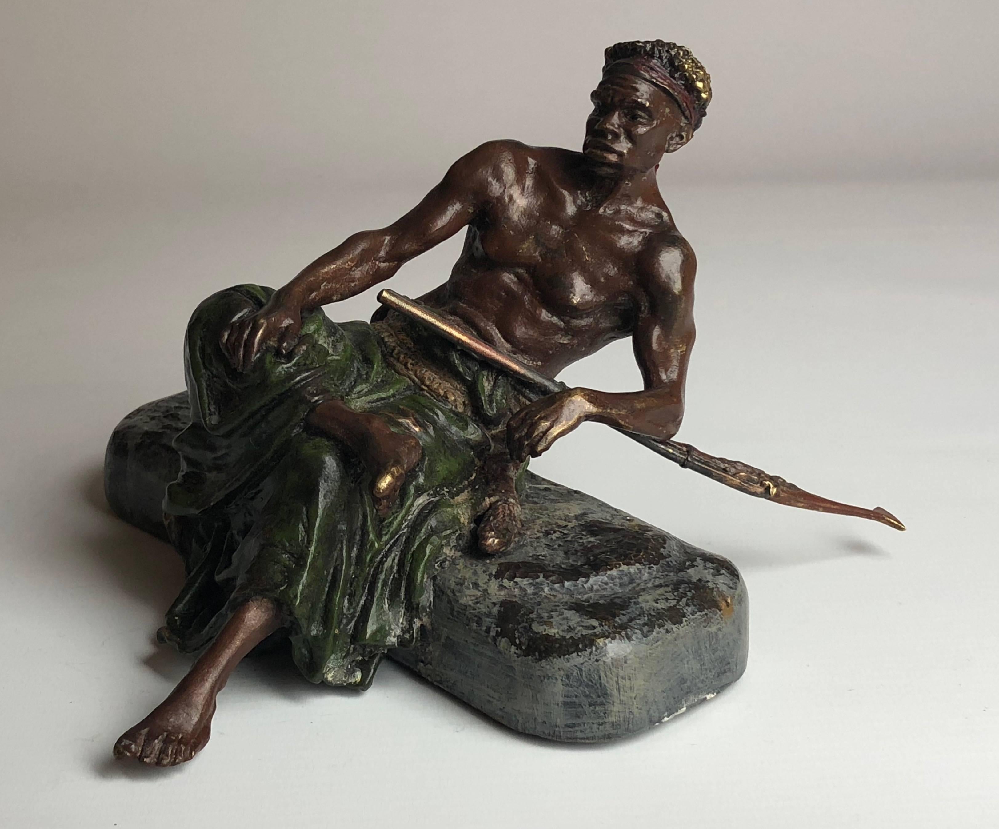 A very fine early 20th century cold painted Austrian bronze study of a black man seated with rifle

The piece measures 7