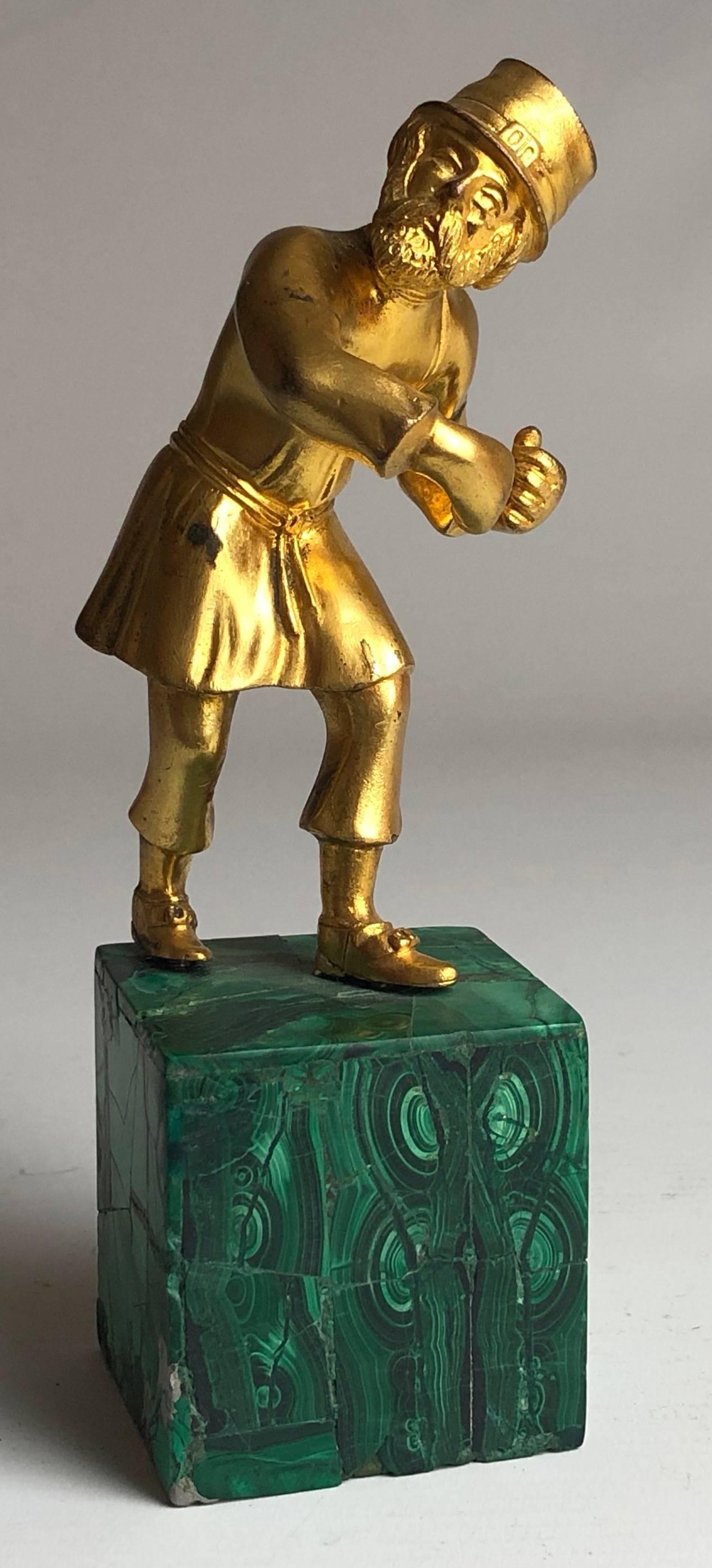 An early 20th century Russian gilded bronze, finely modelled as a traditional Cossack, on a Malachite base,

Russian, circa 1900.

Measure: He stands 6