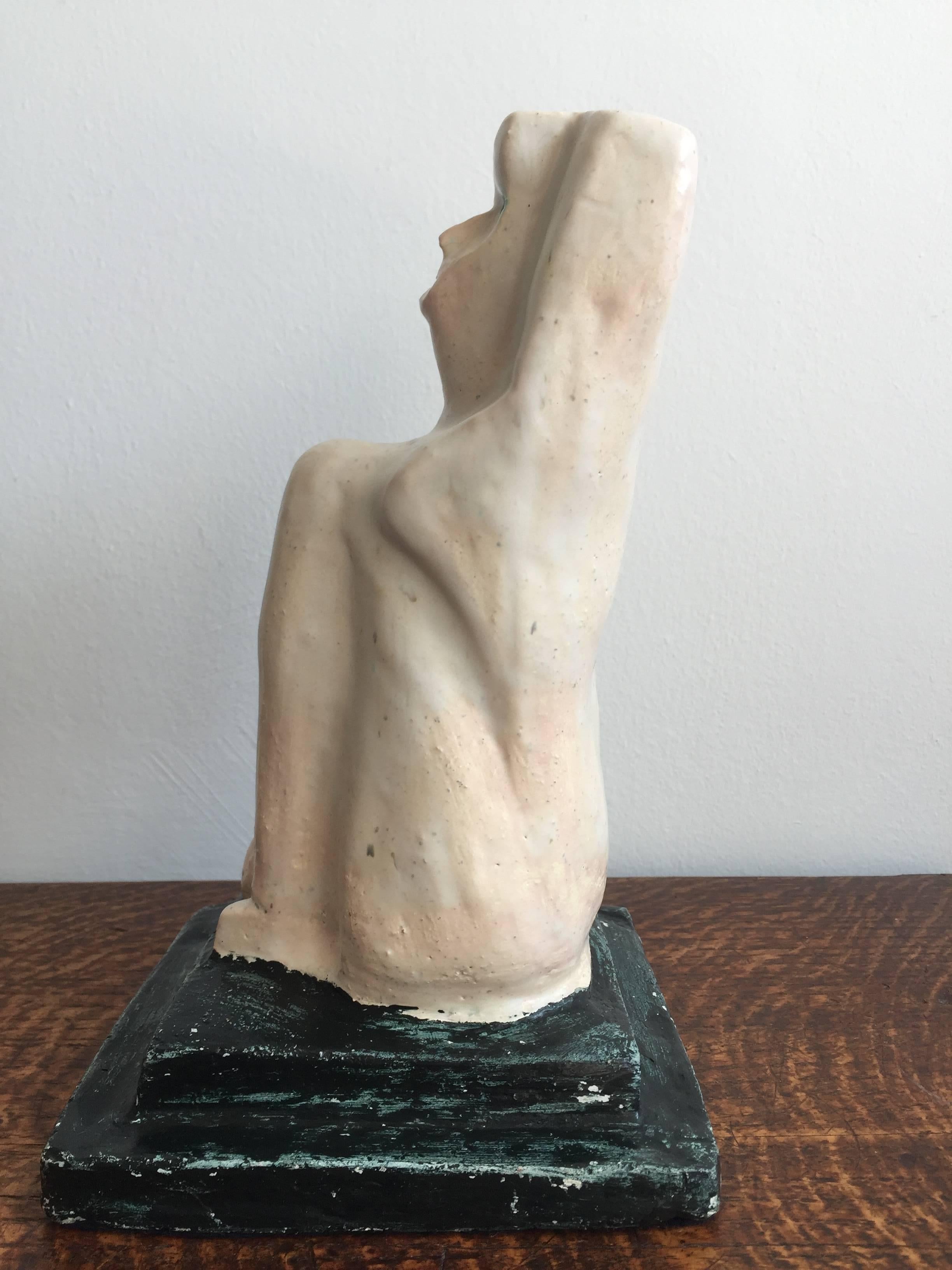 Abstracted pottery figure the torso in pink-white glaze the base in unfired green paint. Dates to circa 1940s-1950s. Signed to the base "Paulin". Pierre Paulin is known to have trained in Vallauris as a potter before turning to furniture