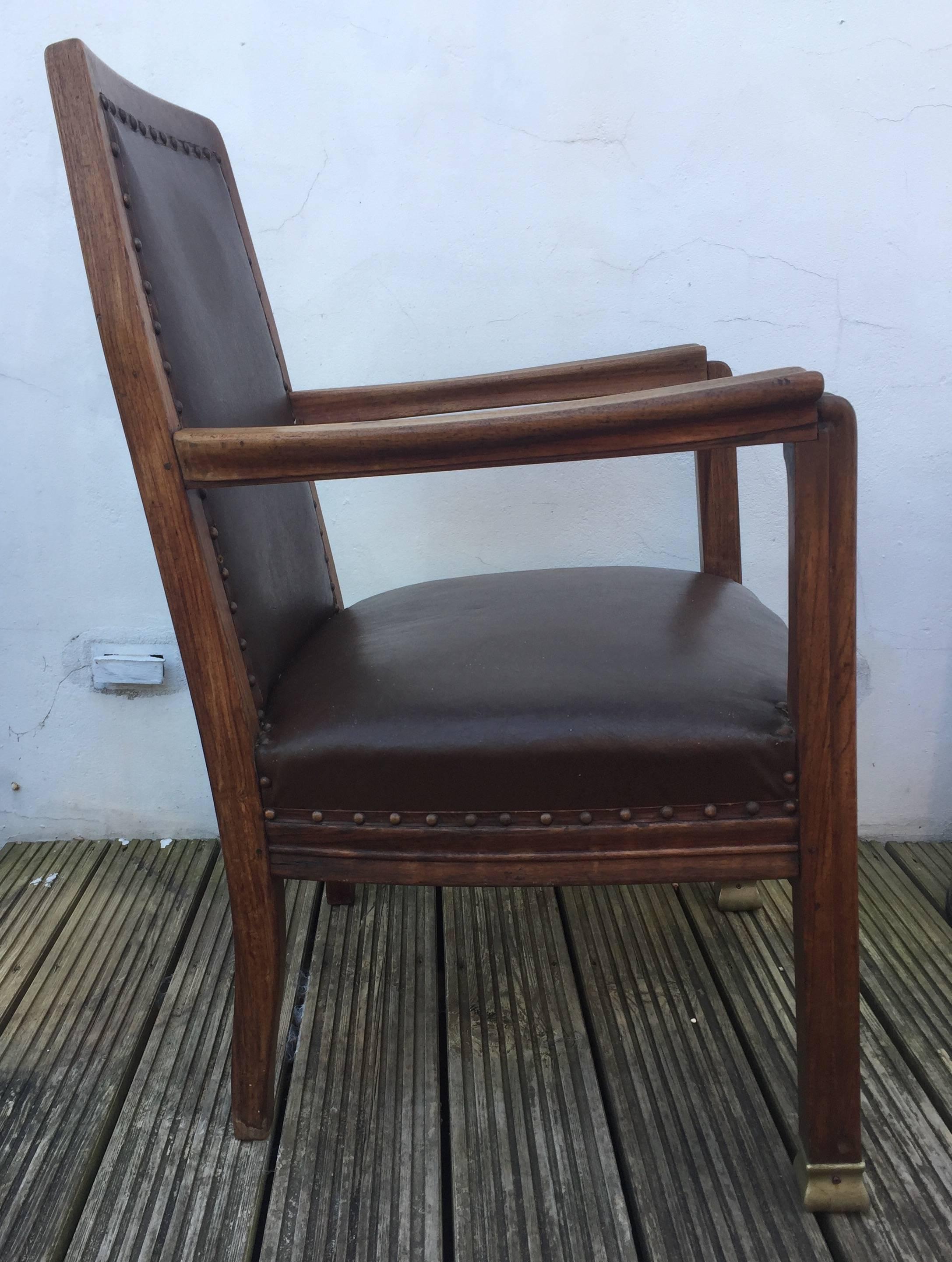 Heavy and high quality solid walnut lounge chair with later reupholstering dating to circa 1910 in the manner of Henri Van de Velde. The shallow carved details and ergonomic shaping of the arms signal a far higher level of design quality than