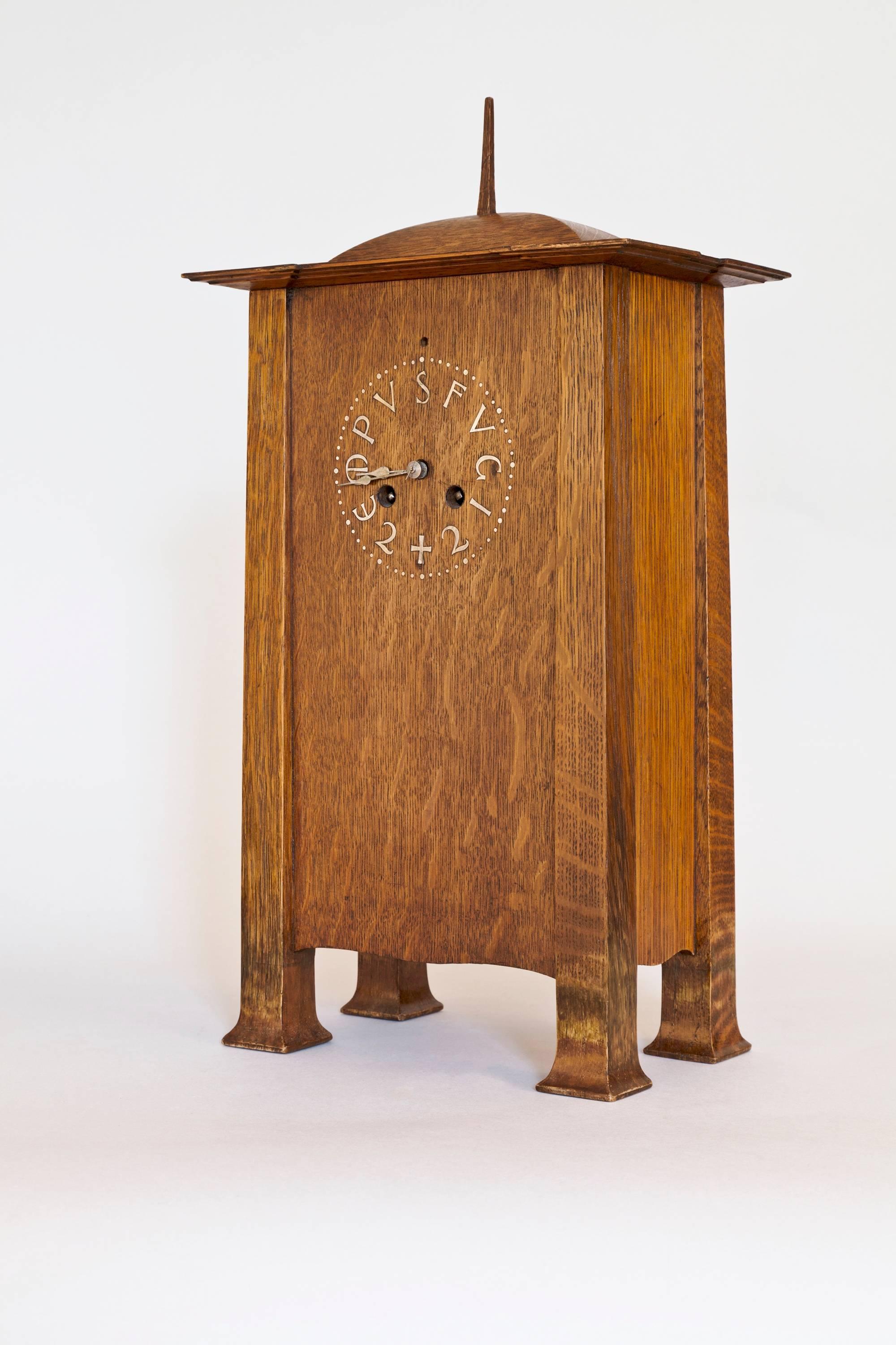 An incredibly rare oak (with pewter inlaid dial) Arts & Crafts oak clock of architectural form, by arguably the top British Arts & Crafts architect of all, Charles Francis Annesley Voysey, circa 1905. Made for him by Frederick Coote. The stylized