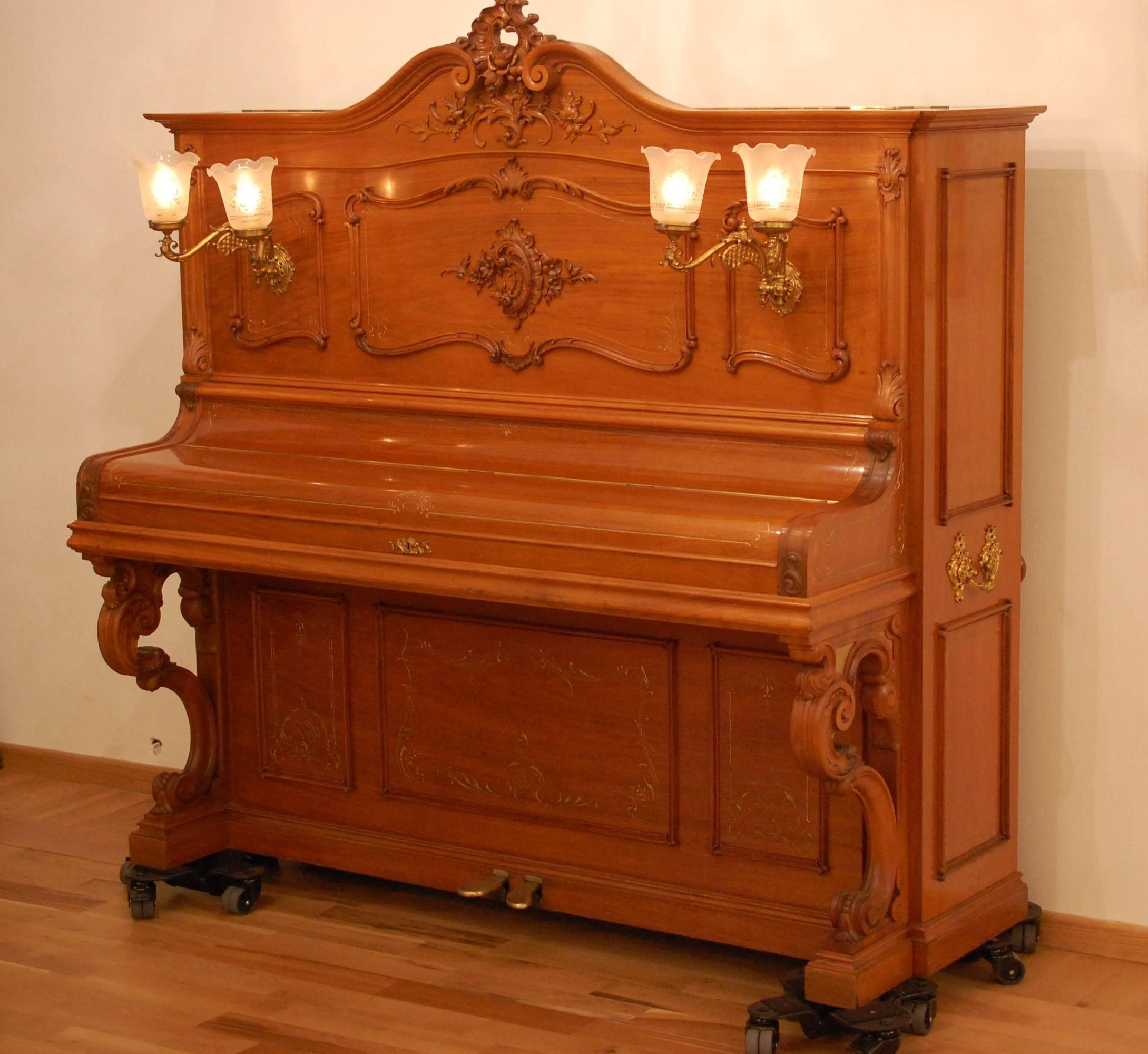 One-of-a-kind upright Art Case piano by Julius Blüthner, Leipzig, Germany. Serial number 57984, year 1901. 88 keys. The sumptuous walnut case is sculpted in a Louis XVI rococo style. Engraved motifs and designs in frame patterns are highlighted in