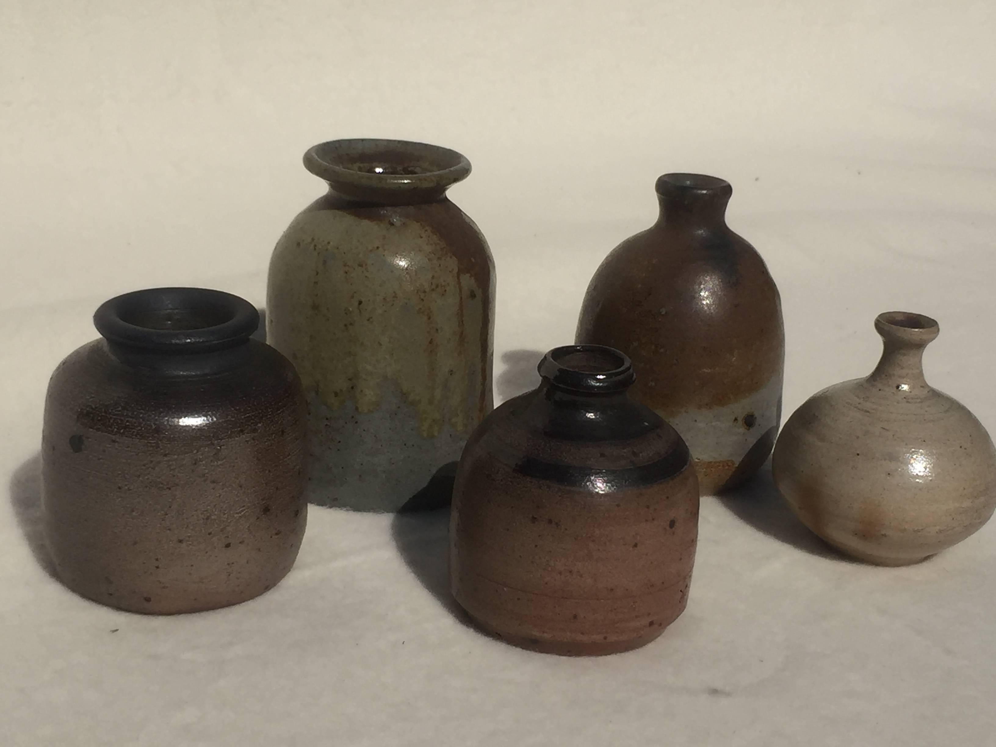 A set of five unique Miniature art pottery vases by Lilo Grinzoff-Assenmacher, Germany, 1960s. Turned and salt glazed in grey, brown, green and grey-blue with a mother-of-pearl shimmer.
Measures: The largest one is 3.9''/ 10 cm high, Ø 2.9''/ 7.4