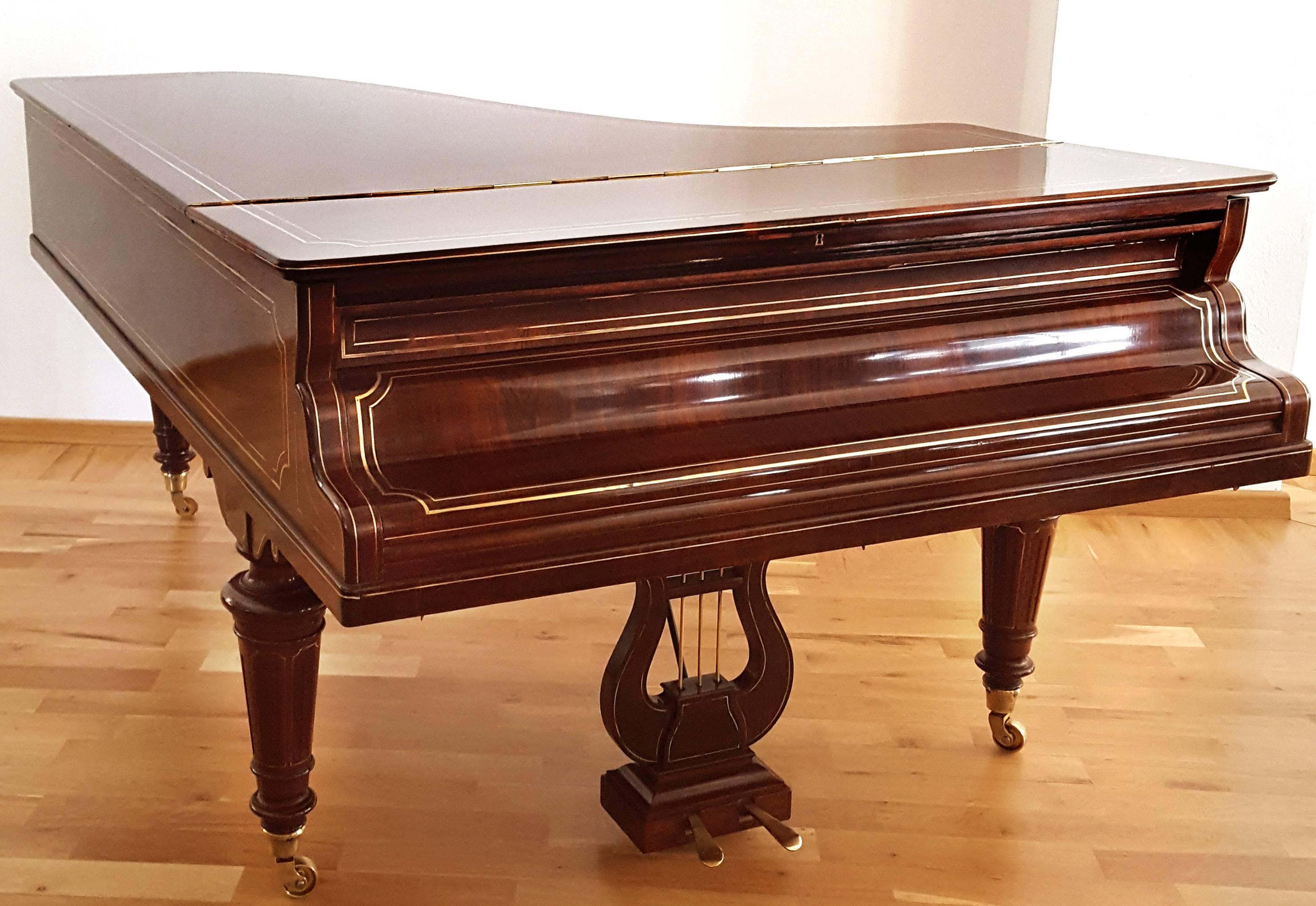 Erard grand serial number 49613 made in the year 1875 in a beautiful stunning case of dark rosewood with bands of brass inlay enhancing the cases beauty. This outstanding rare grand piano has been restored by our specialists keeping all its original
