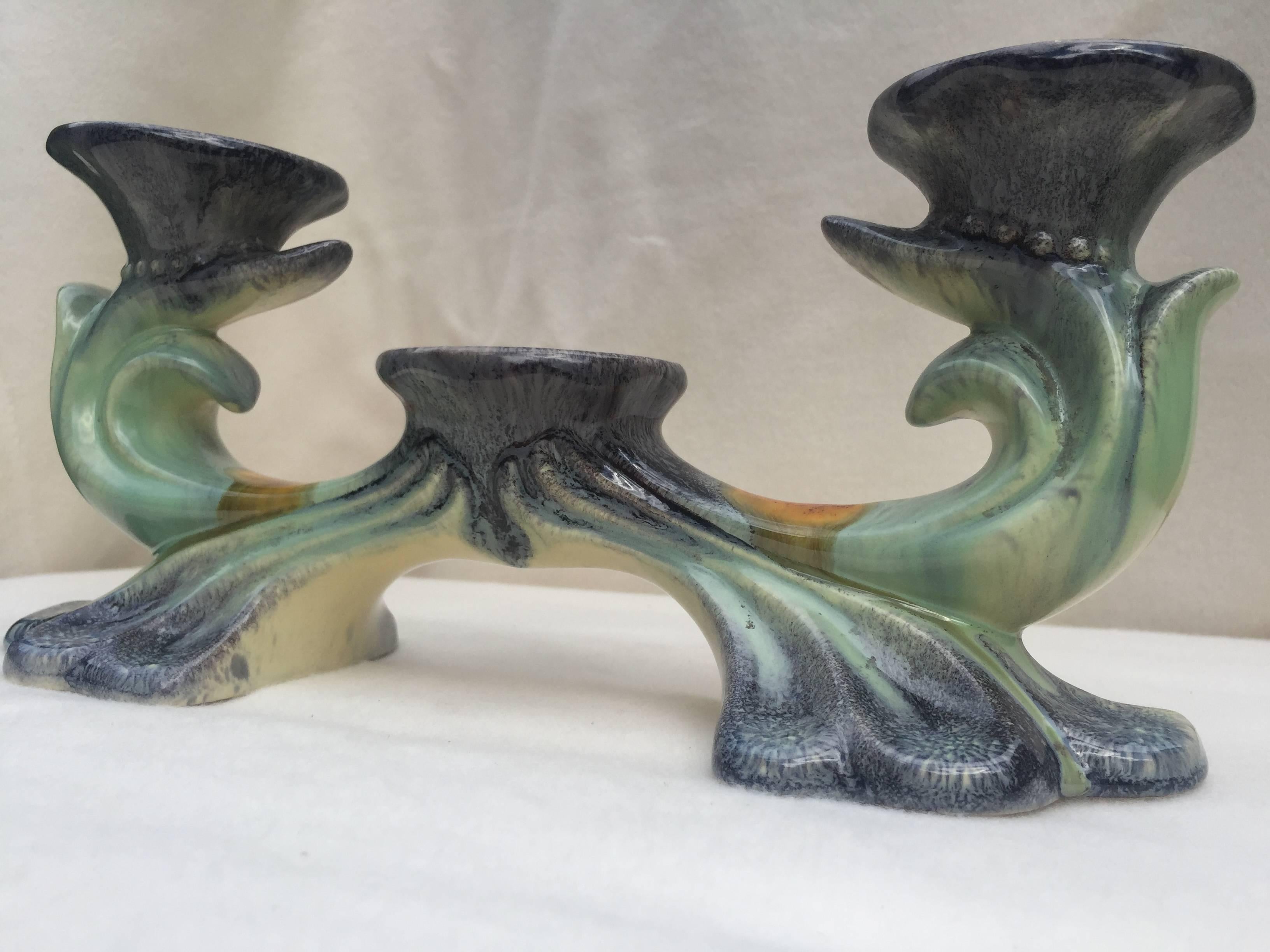 Glazed candleholder, circa 1930 in a free plant form shape with glossy glaze in green, blue and orange, marked underneath, Germany 596.
The inner diameter of the holes are 4.5'' for normal candles.