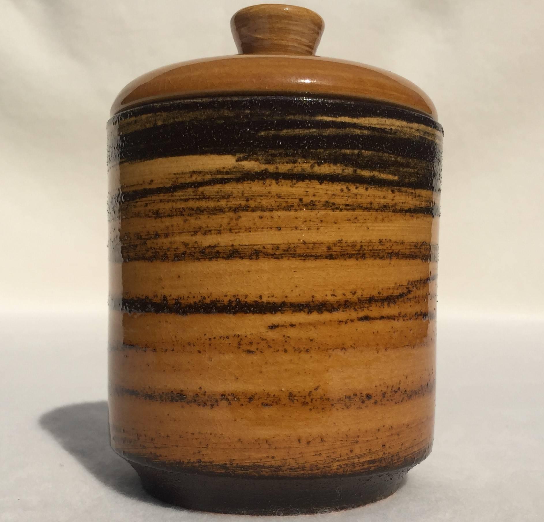 A rare ceramic jar, box with a lid in a gold-yellow and brown glaze from Höhr-Grenzhausen, Westerwald, Germany, circa 1960. Stamped underneath D&B, Höhr, Handwerk (Arts and Craft).
This jar comes from the famous pottery village