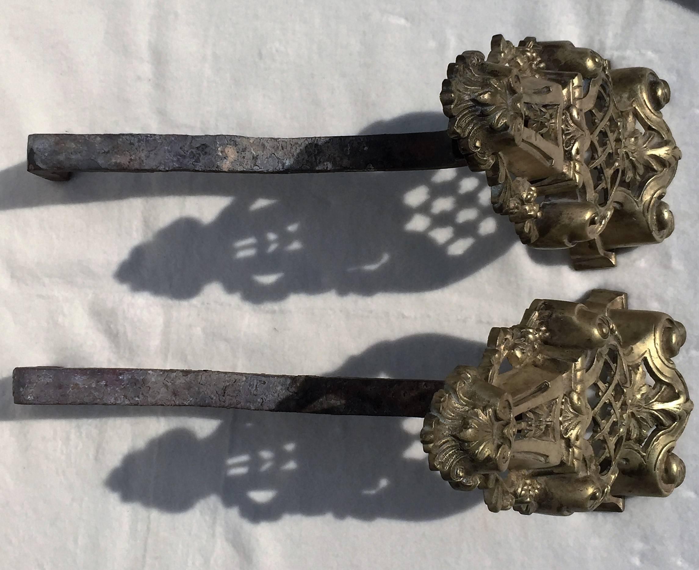 French Louis XV Rococo style 19th century bronze andirons, fire dogs, chenets, 1860-1880. 
They have been cleaned professionally. 
It's having a screw to adjust the angle of the iron rack.
Provenance from a French chateau.