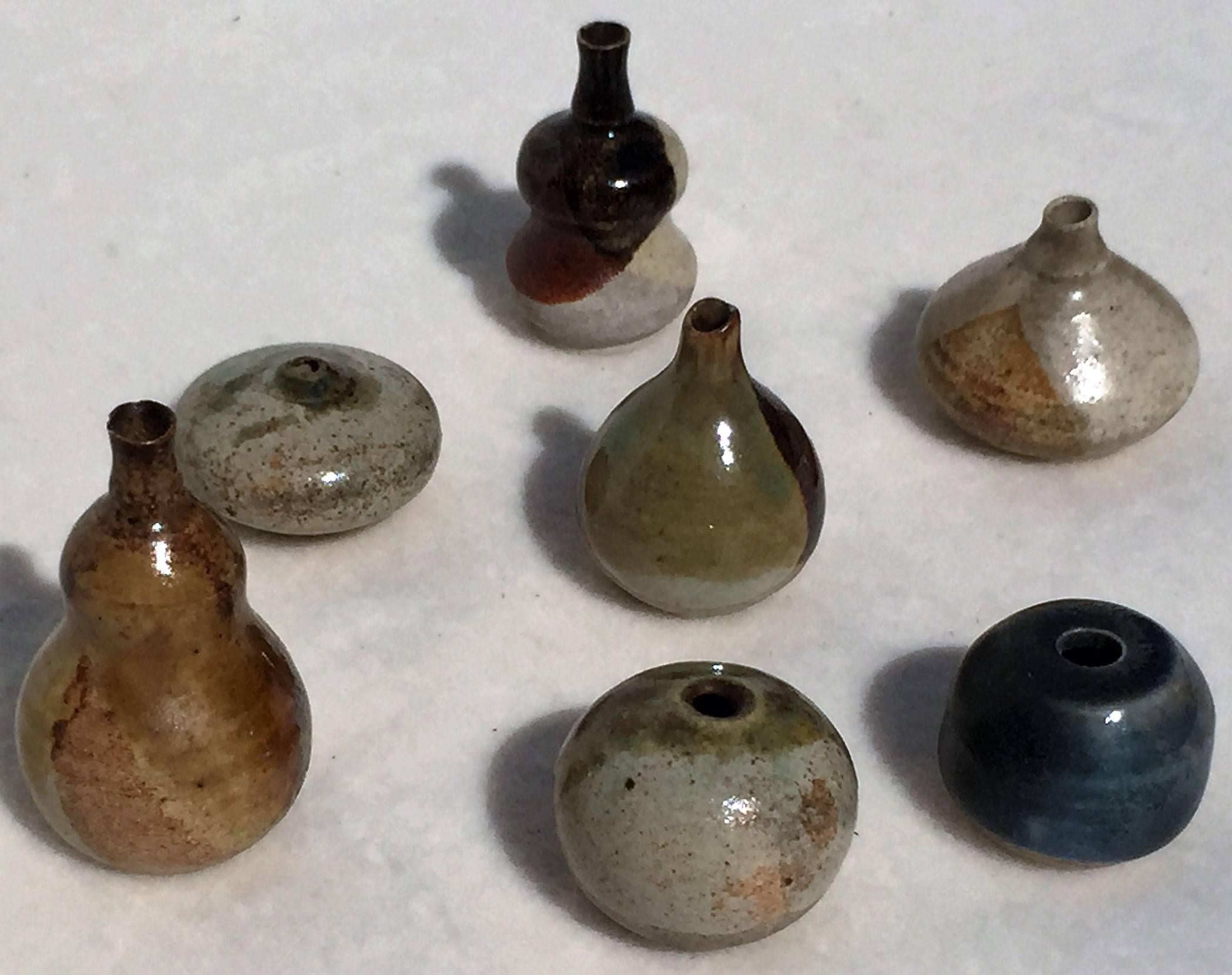 A set of seven tiny turned Miniature vases. In brown, blue, green glaze. Fruit and spherical shaped. Signed underneath TS. From the village of Art pottery Höhr- Grenzhausen, Westerwald, Germany, 1960s.
The largest one is 2.24''/ 5.7 cm high, Ø
