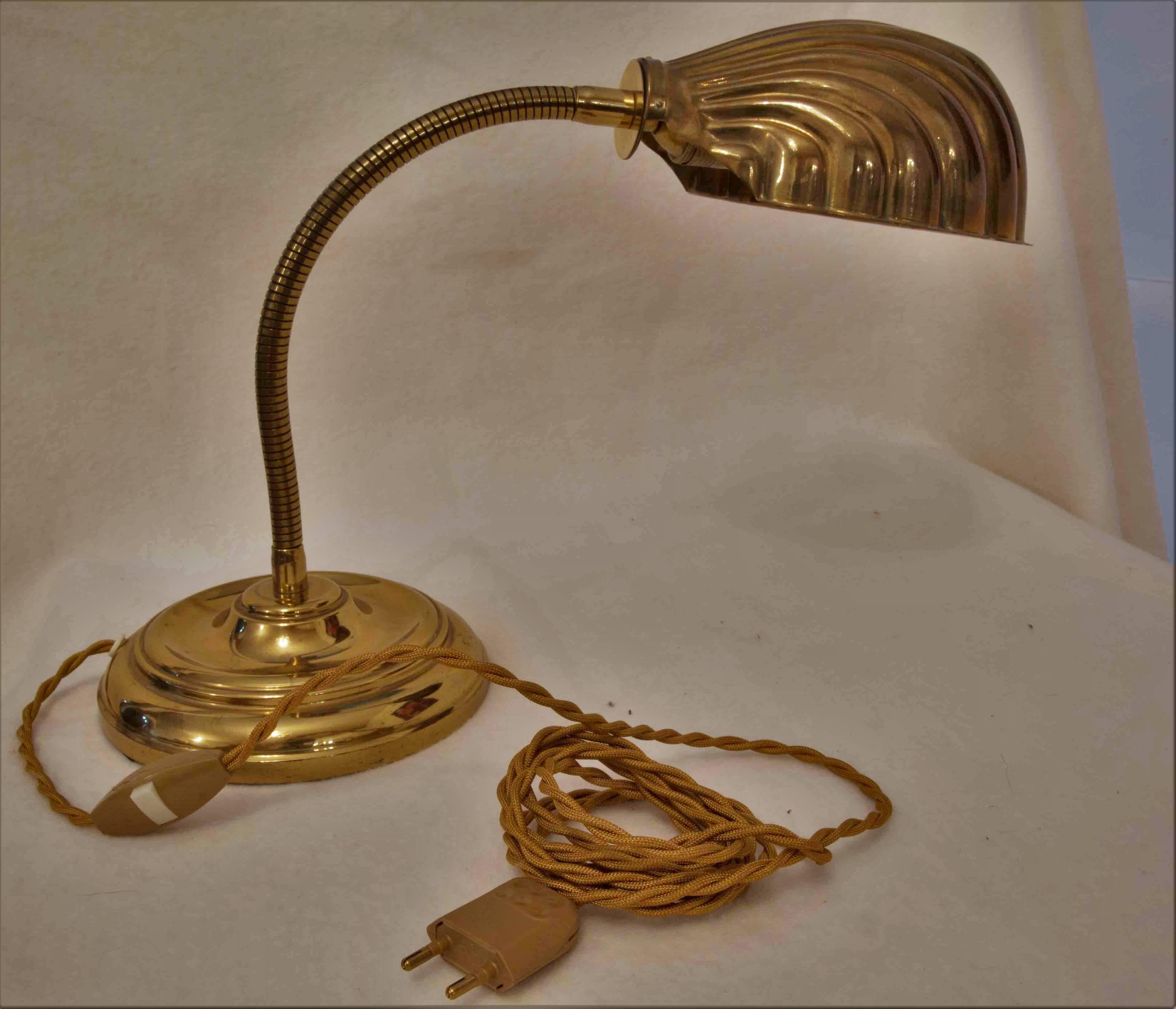 An elegant Art Nouveau revival brass desk lamp with a flexible column and a turnable shell-shaped shade.
Newly rewired using a textile cable.