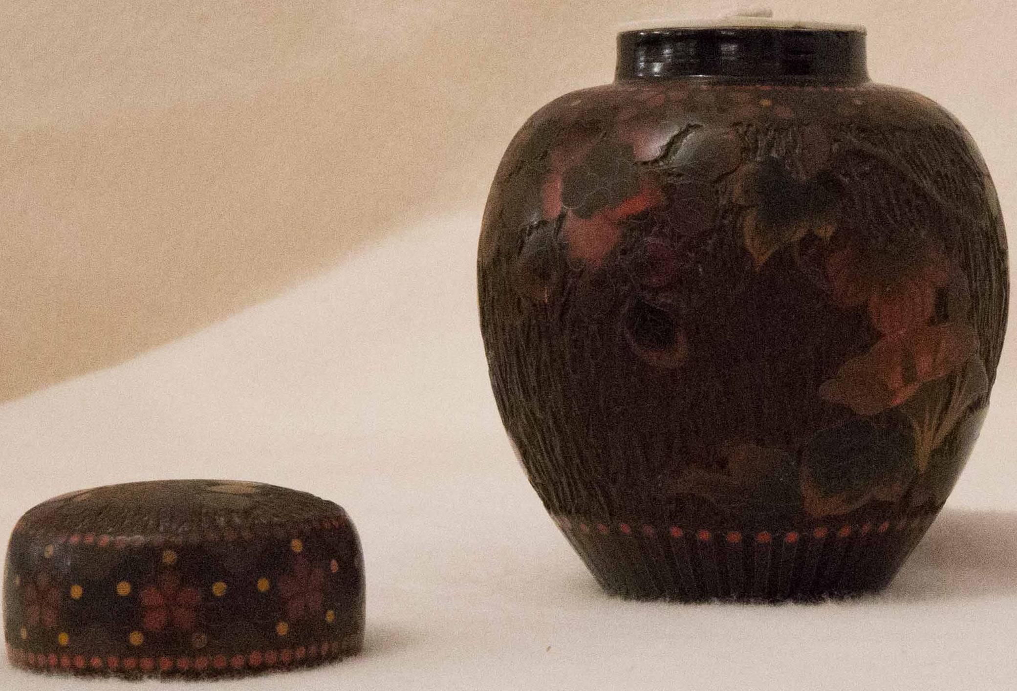 Enamel cloisonneé on porcelain (jiki shippo) tea caddy having rare earth colors and design. The jiki shippo technique imitates tree back. The lacquered surface of black and brown, with merging orange yellows and red colors all merge into the design