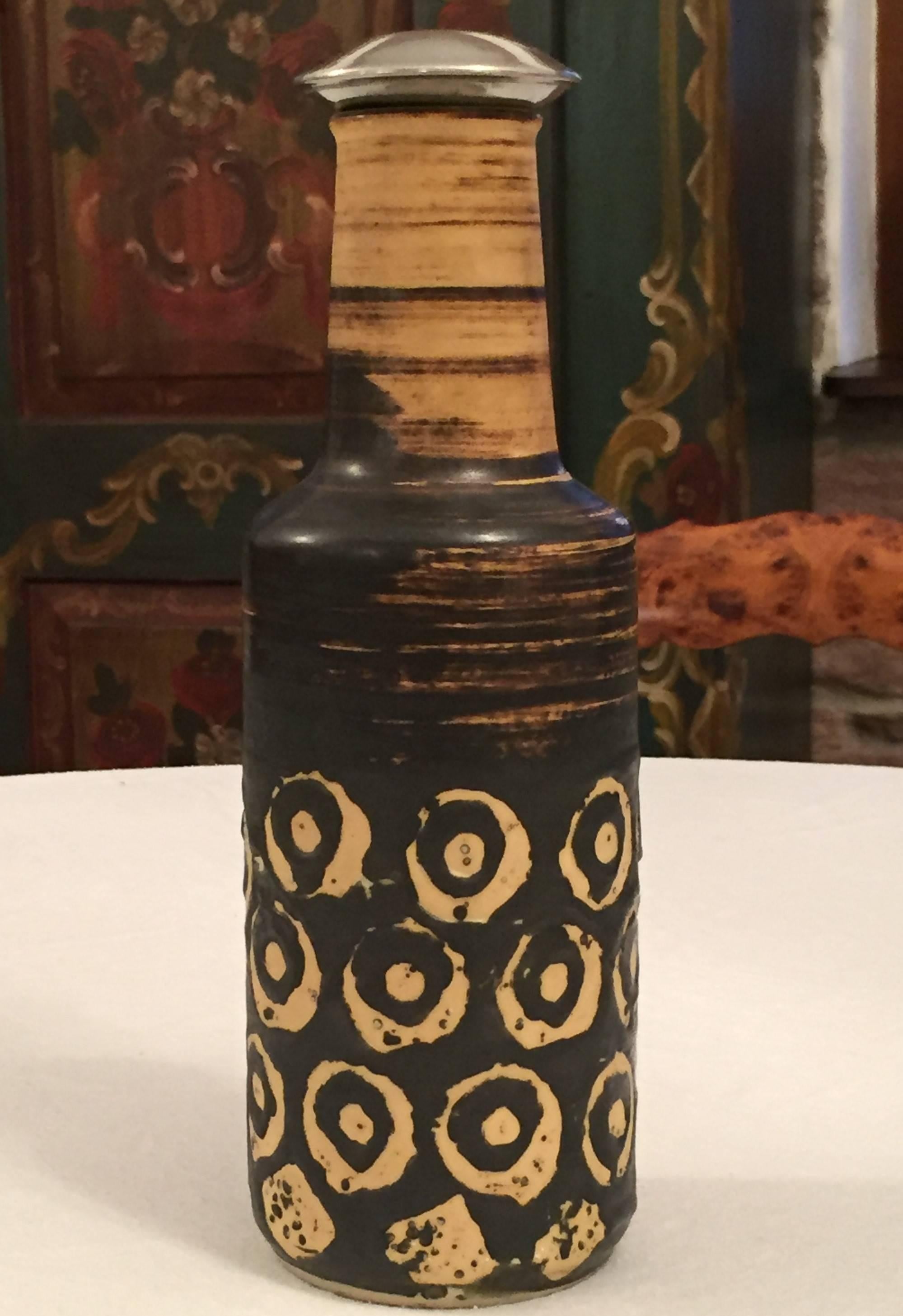 1950s Art Pottery ceramic vase or bottle by Germany. Stamped underneath Germany 147, 25.
Has a Mid-Century Modern satin Volcano or fat lava glaze in caramel and very dark brown, almost black. The spotted vivid, slightly sculptural dark brown glaze