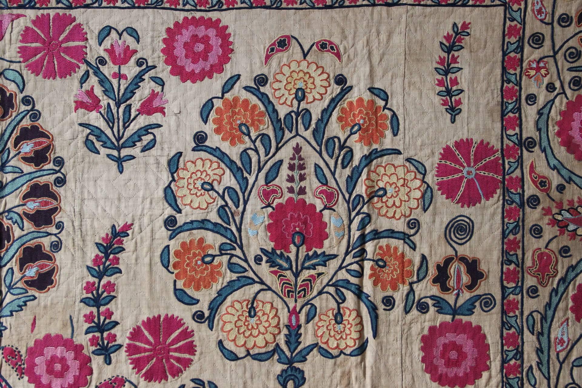 A stunning silk on cotton hand stitched embroidery from the district of Ura Tube, Uzbekistan. Made as a dowry to demonstrate the bride to be's skill with the needle and a not inconsiderable store of wealth, these fabulous objects of art have become