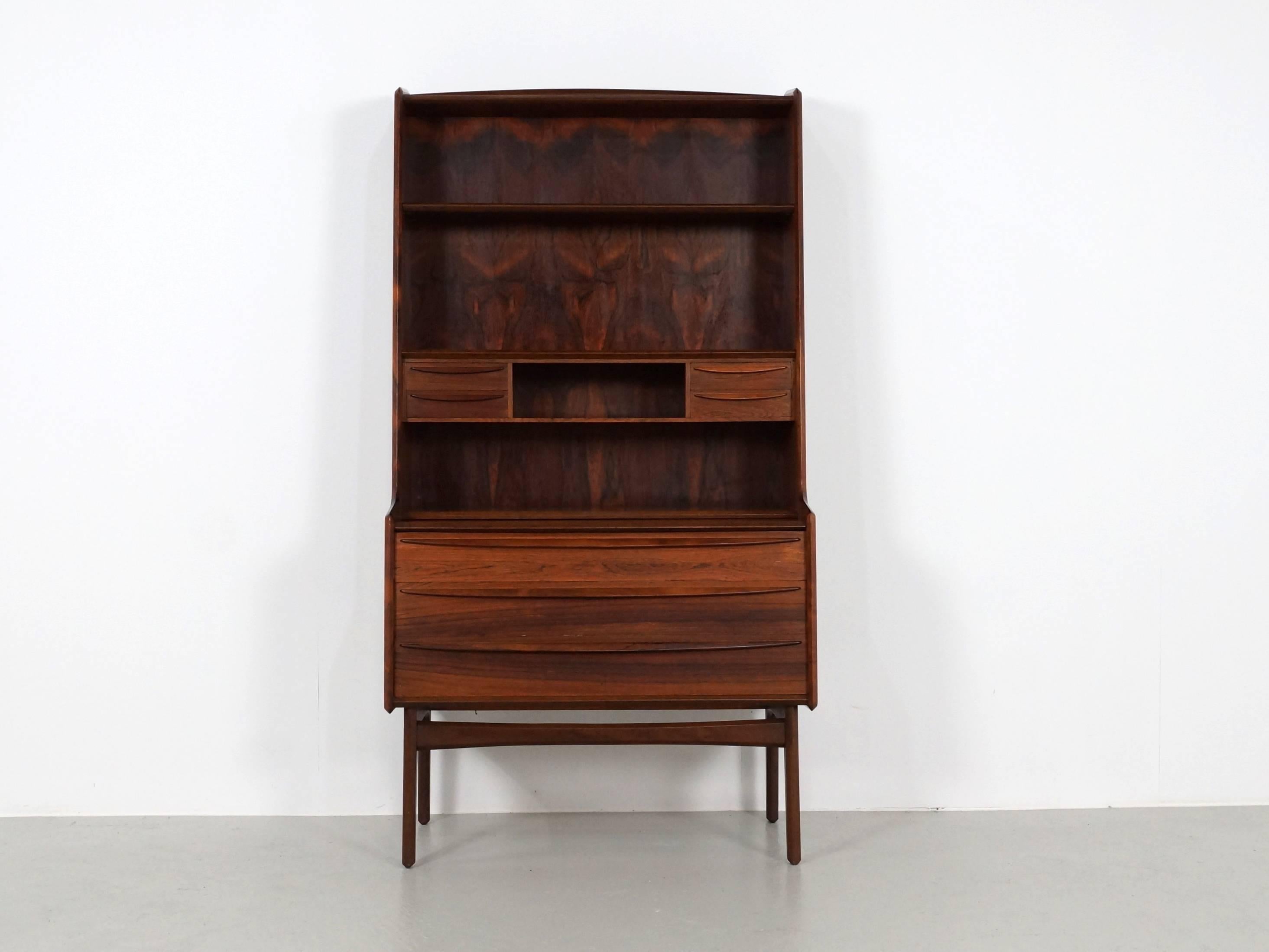 Stunning Mid-Century Scandinavian modern secretary desk in Mahogany 
The pull out shelf is sturdy and great for writing or using your laptop. The lower section has three drawers and the upper section has a section with a series of four small storage