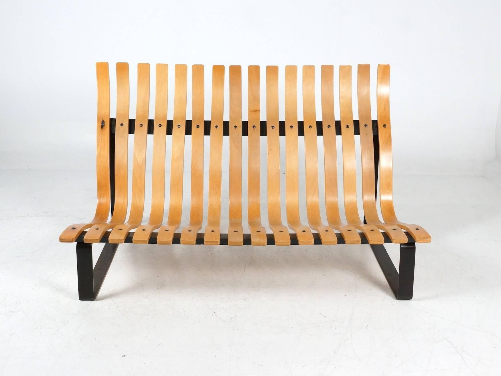 This rare and hard to find bentwood slatted bench was designed by Kho Liang Ie for Artifort at the end of the 1960s. 
The bent wooden slats with the contrasting black frame has an open character. This bench was inspired on the C683 from Artifort
