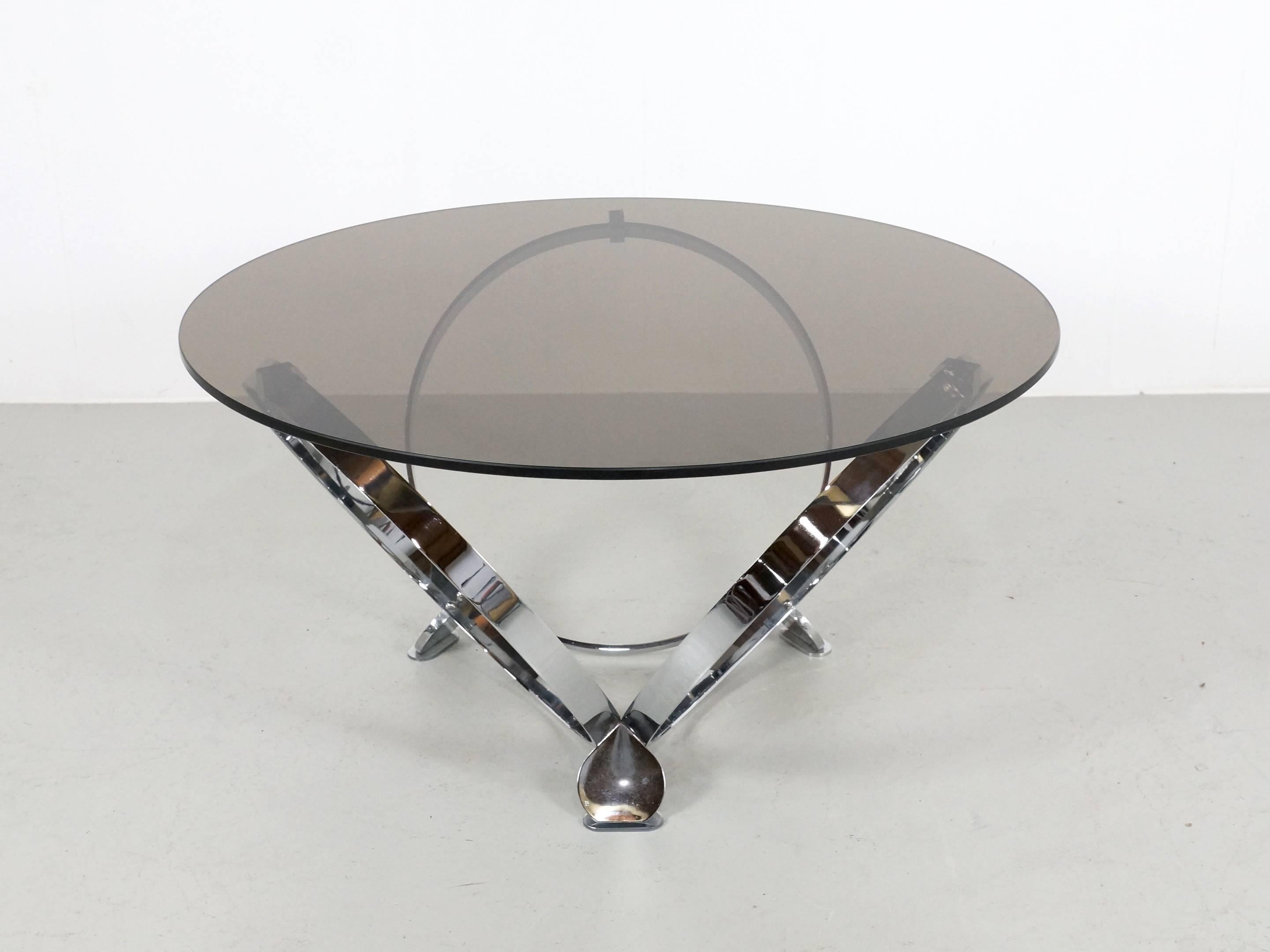 Beautiful chrome base with smoked color glass top coffee table from the 1970s. Designed by Knut Hesterberg. The chrome base in in very good condition with minor wear and the glass top has some small minor scratches. On request we can replace the