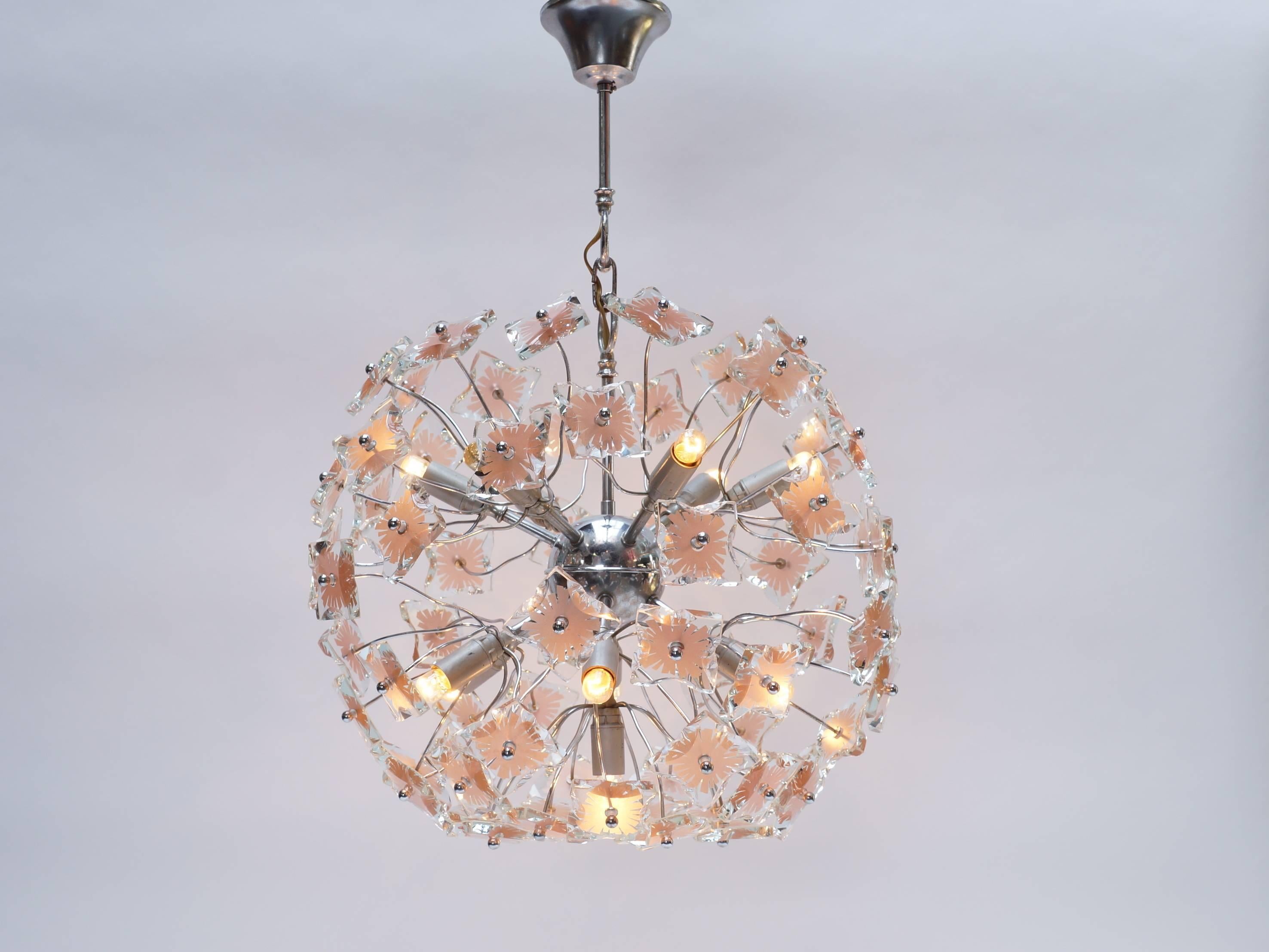 Stunning Mid-Century Chandelier in the style of Fontana Arte with eleven lights (E14) Madden the 1970s in the style of Italian Sputnik chandeliers but then with glass. This lamp is in very good condition and fully working. When its turned off it