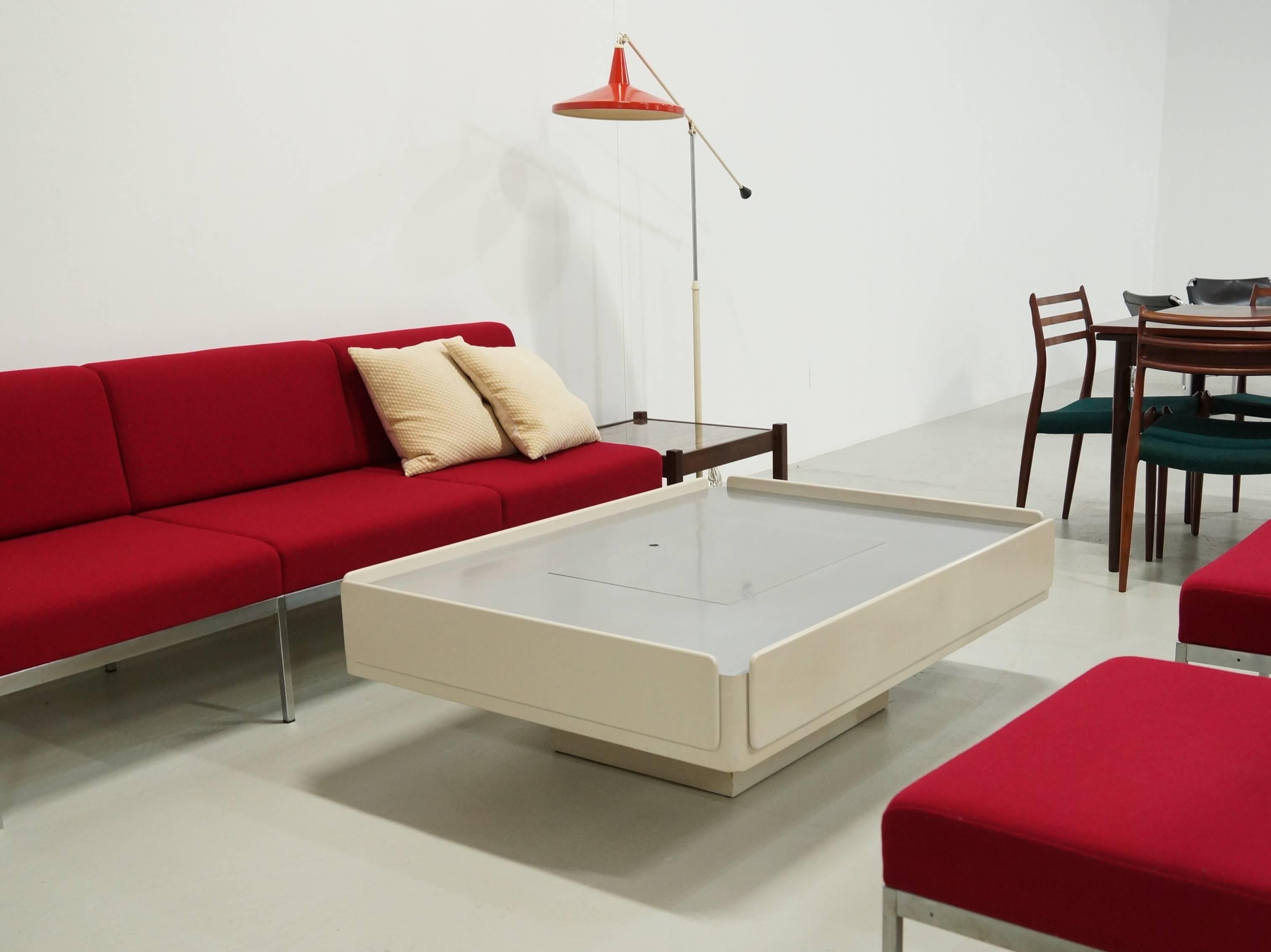 Beautiful off-white coffee table designed by Vico Magistretti model Caori with Record Storage, made by Gavina in 1962. The long sides are two fall Flaps storages and the short sides are two drawers. The stainless steel top contains a storage space