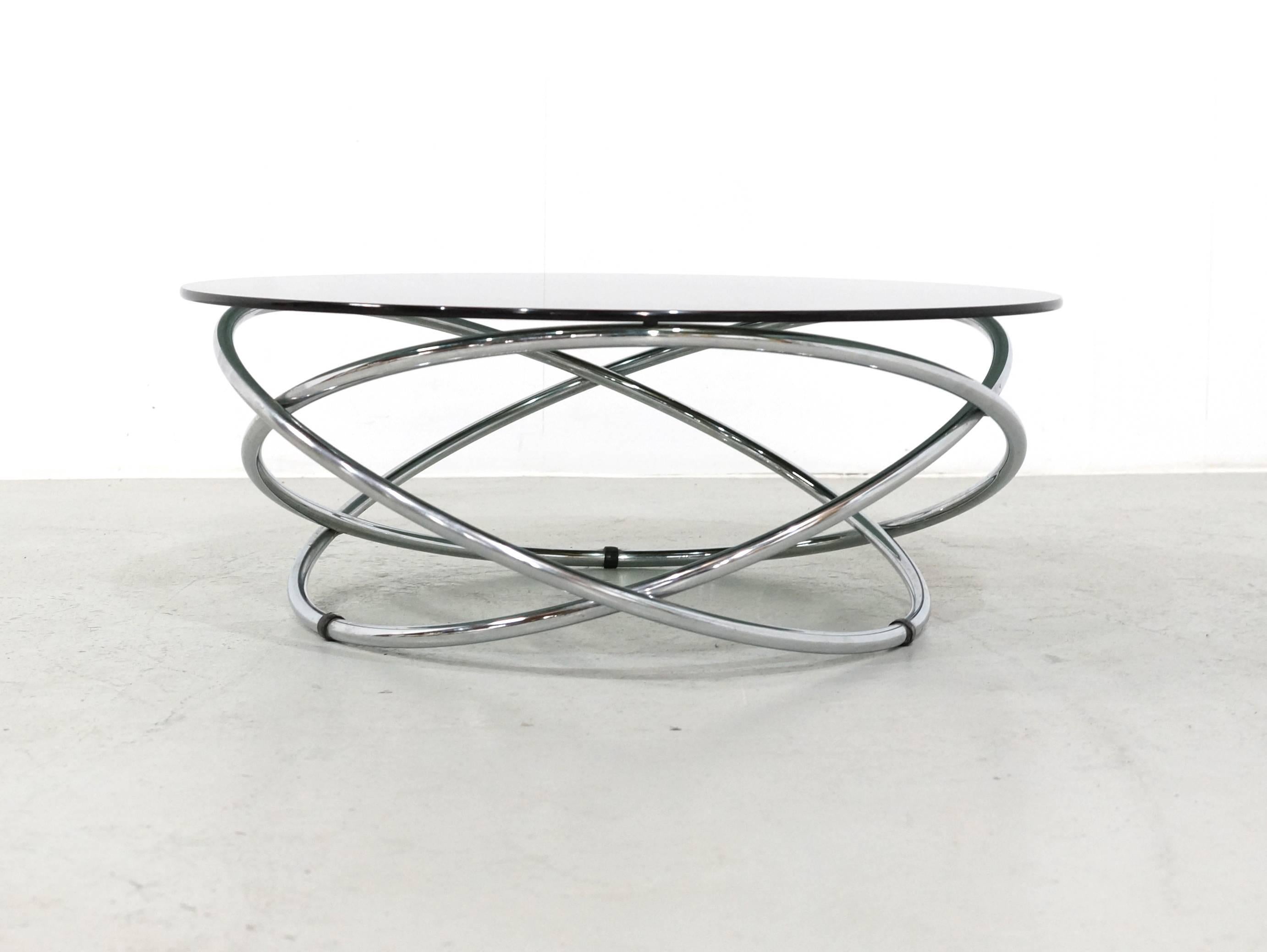 This beautiful Italian coffee could come out of one of the James Bond movies, crazy table with three hovering rings and a smoked glass top. This kind of Atomic style coffee tables are not very easy to find.
This Italian coffee table is in perfect