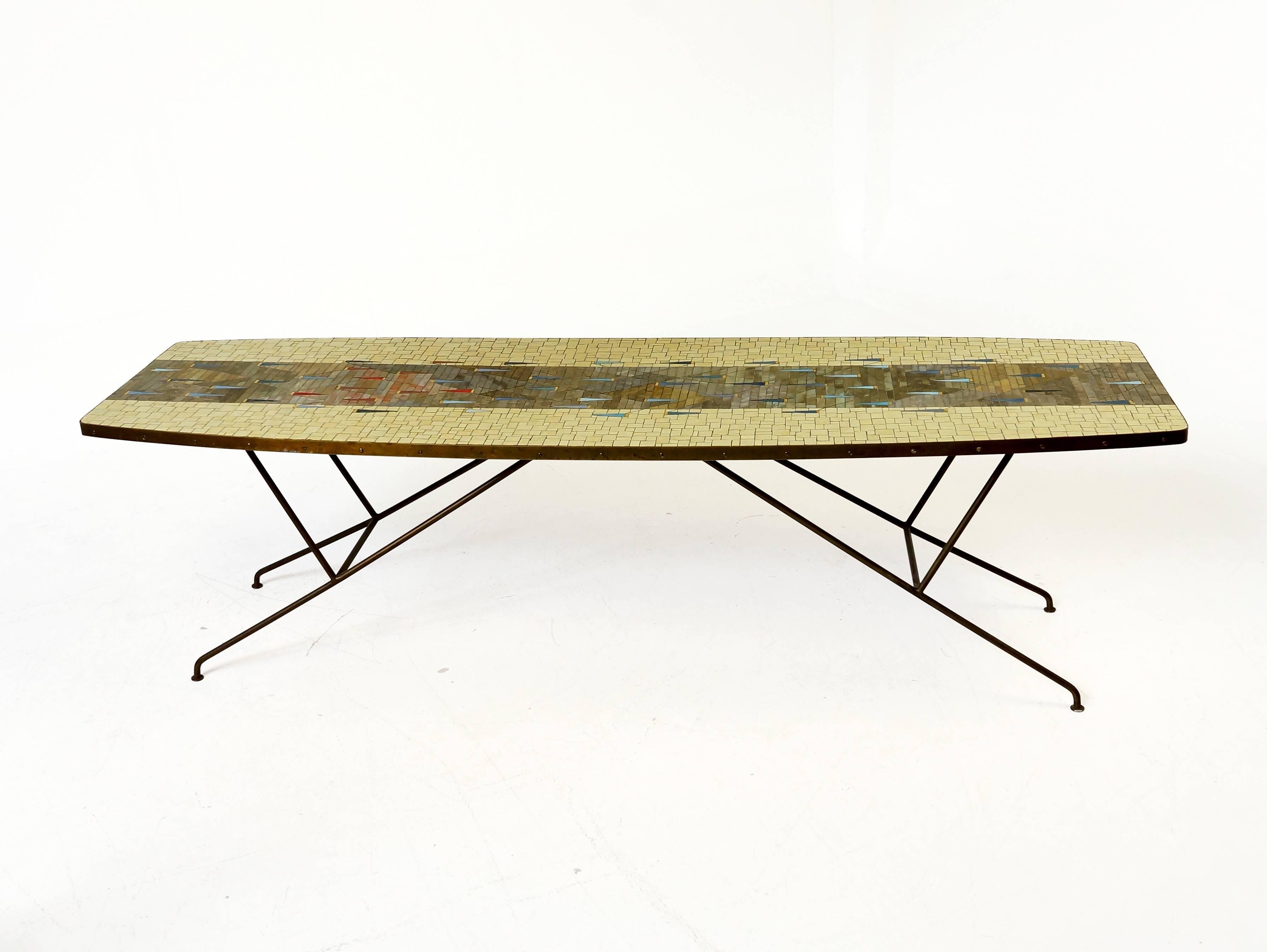 A beautiful, large Italian coffee table with glass mosaic top and impressive brass legs. Made in Italy in the 1950s. In very good condition with patina on the brass edge around the table and the base. To be use as a coffee table or even as a table