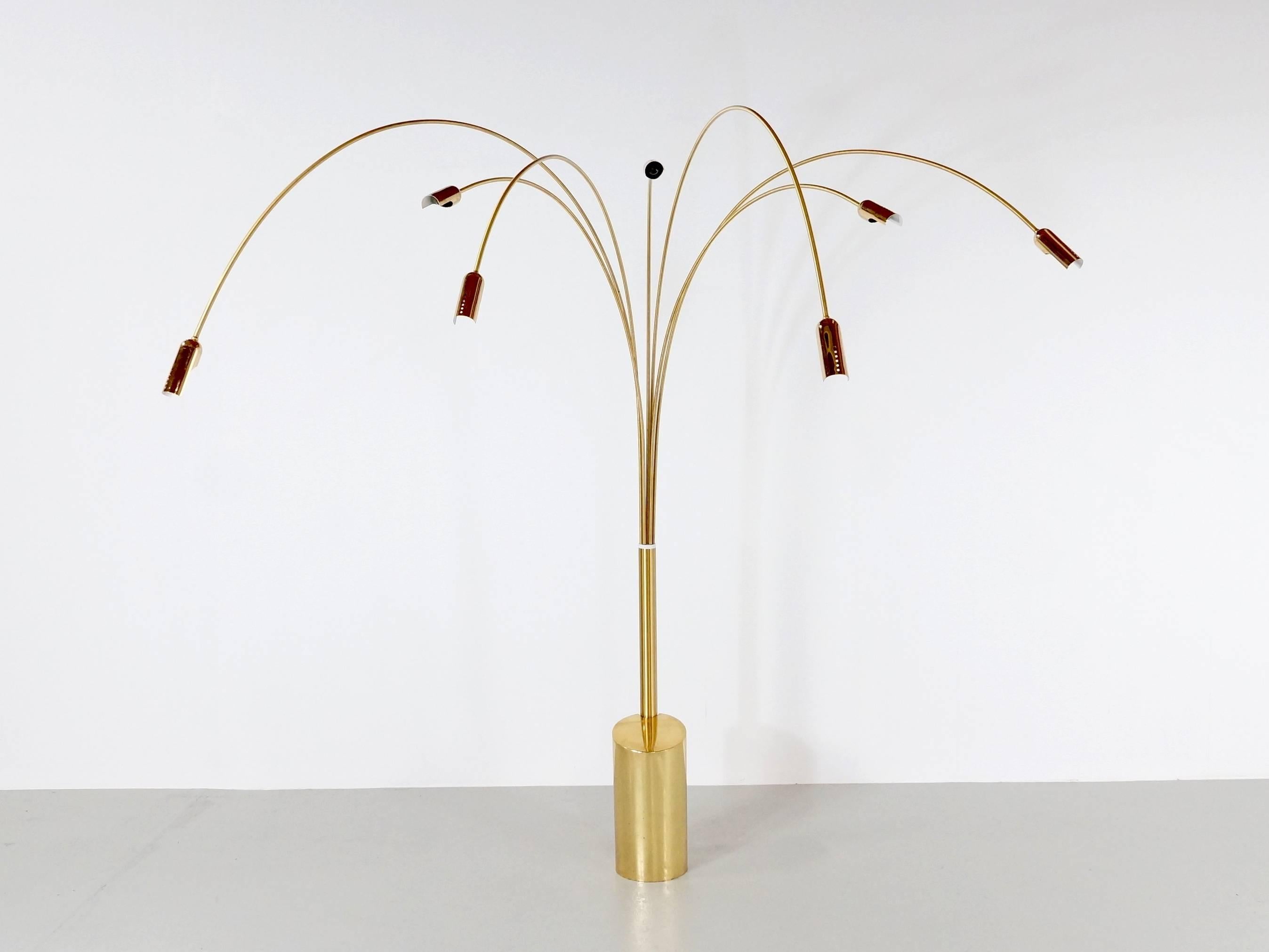 Beautiful brass floor arc lamp with seven arms with on each end one light, this 1970s floor lamp in the style of Maison Jansen is in very good condition and fully working and functional. The Massive 25 cm Diameter brass base makes the lamp very
