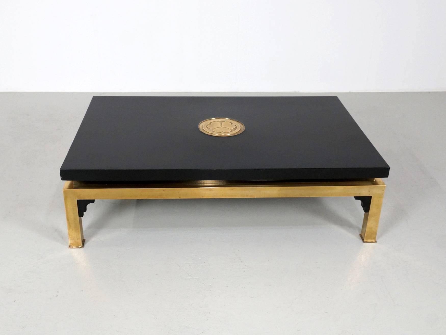 Very exclusive and elegant Italian coffee table designed by Tommaso Barbi. This table only produced in a small quantity. The Beautiful Polished brass base with deep black lacquered wood give it a luxury gloss.
The brass circular plate in the