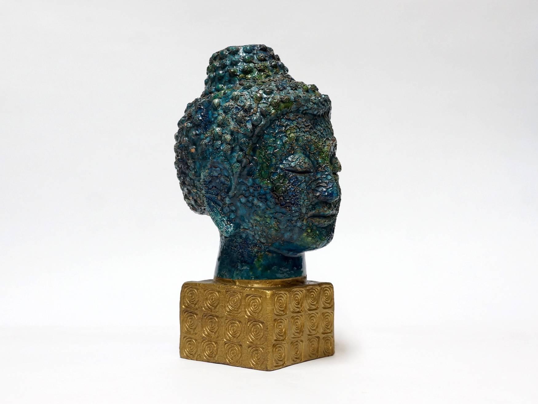 Aldo Londi Buddha head sculpture for Bitossi Italy, made in the 1960s as part the "Cinese" [Chinese] series with Asian inspired pieces.
The mottled, bubbled and textured green, copper-brown and blue glaze was inspired by ancient Chinese