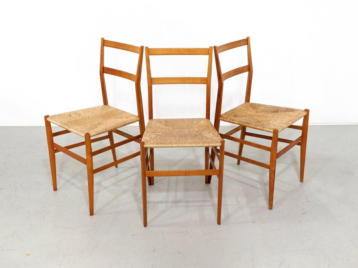 Great set of three Gio Ponti most Famous Superleggera in an early 1950s edition from Figli Di Amedeo Cassina. This set of three chairs are made in ashwood and in great vintage condition. The seats are in original condition and the wood has a