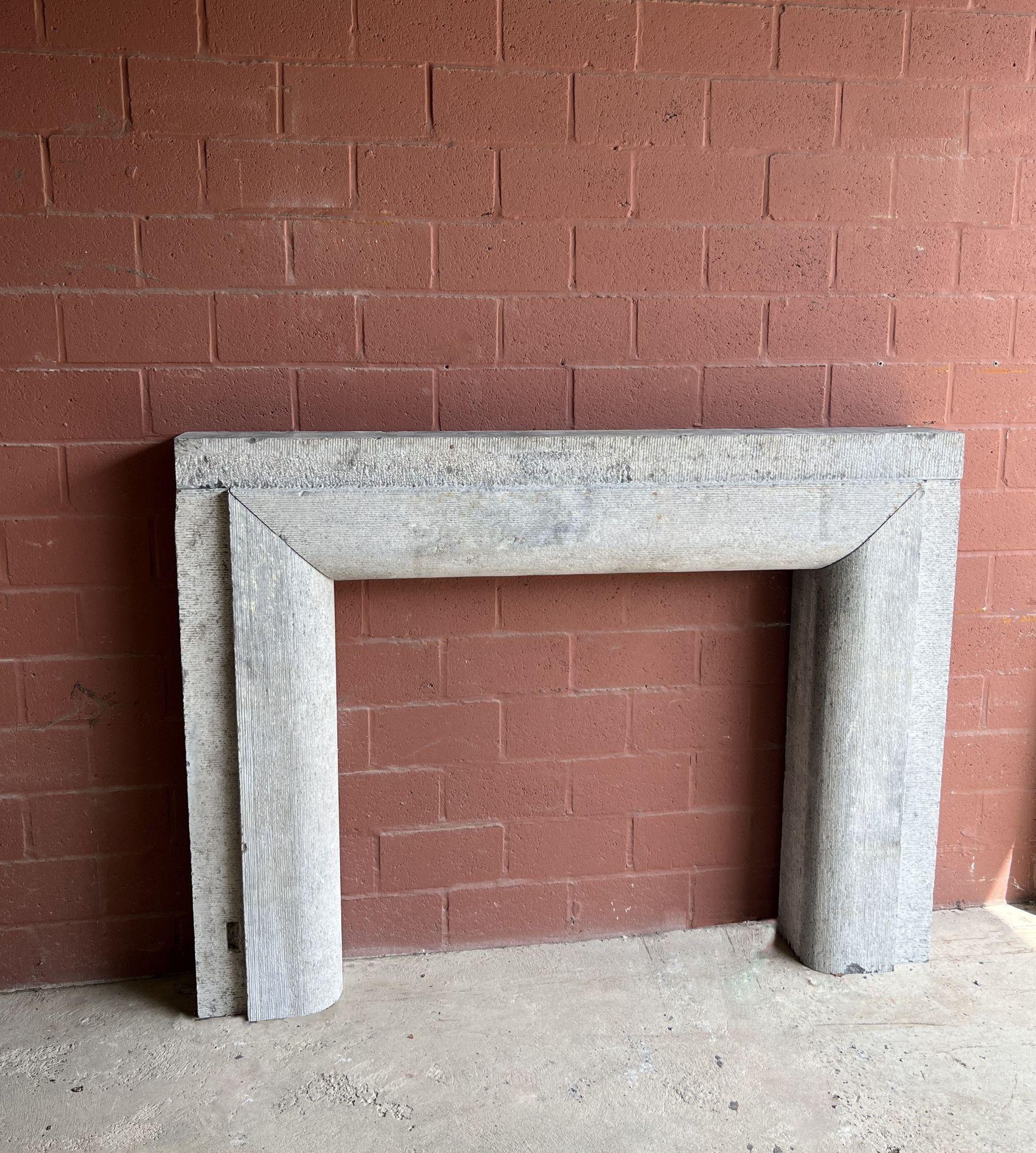 A unusual French Normandy mantlepiece probably from the 19th century. Made in a purified Louis XIV style with perfect proportions. This piece most likely was used in a kitchen because of the remnants of iron attachments to lock kitchenware/grates