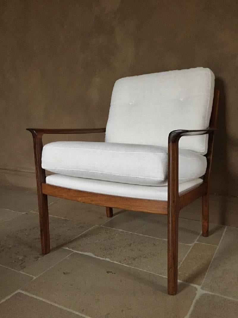 Great quality Ole Wanscher  armchair in beautiful pallisander with linen cushions. Its elegant lines combined with the exotic hardwood and soft linen make it a great asset for every room.