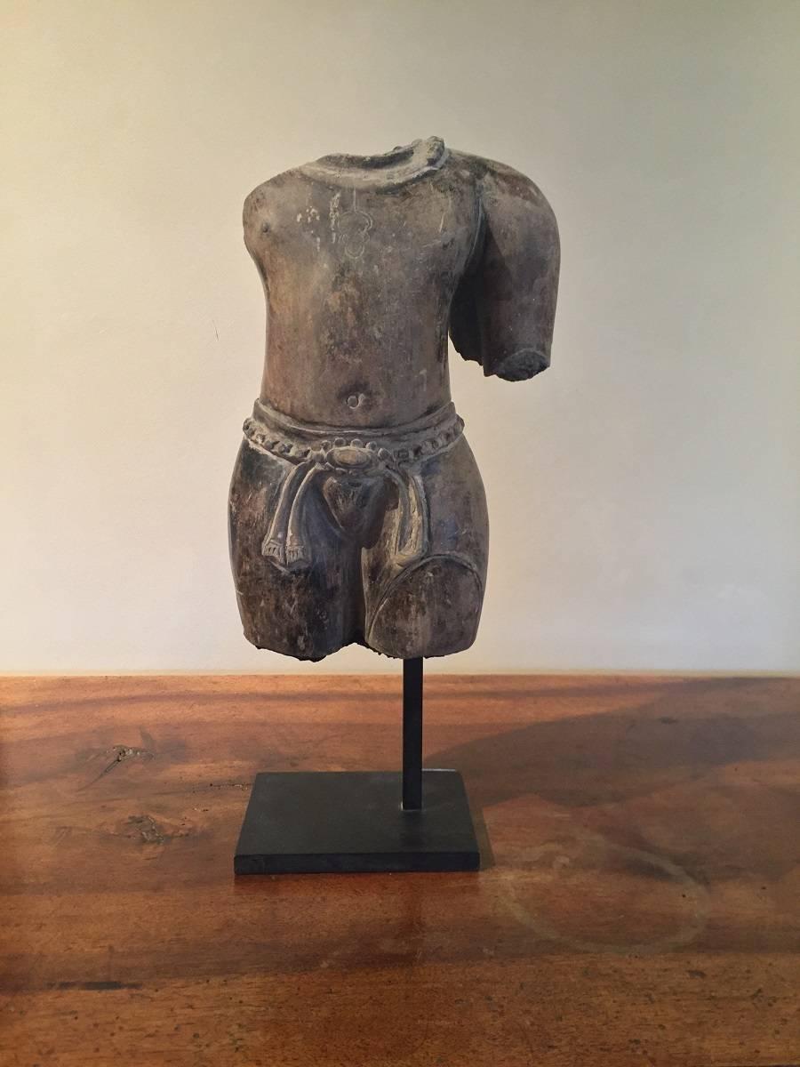 This Torso is a elegant example of the Khmer Culture which flourished between the 9th and 15th century in nowadays Cambodia. Probably the most famous Khmer site is Ankor Vat. Influenced by China, India and Boedhism they also incorporated existing