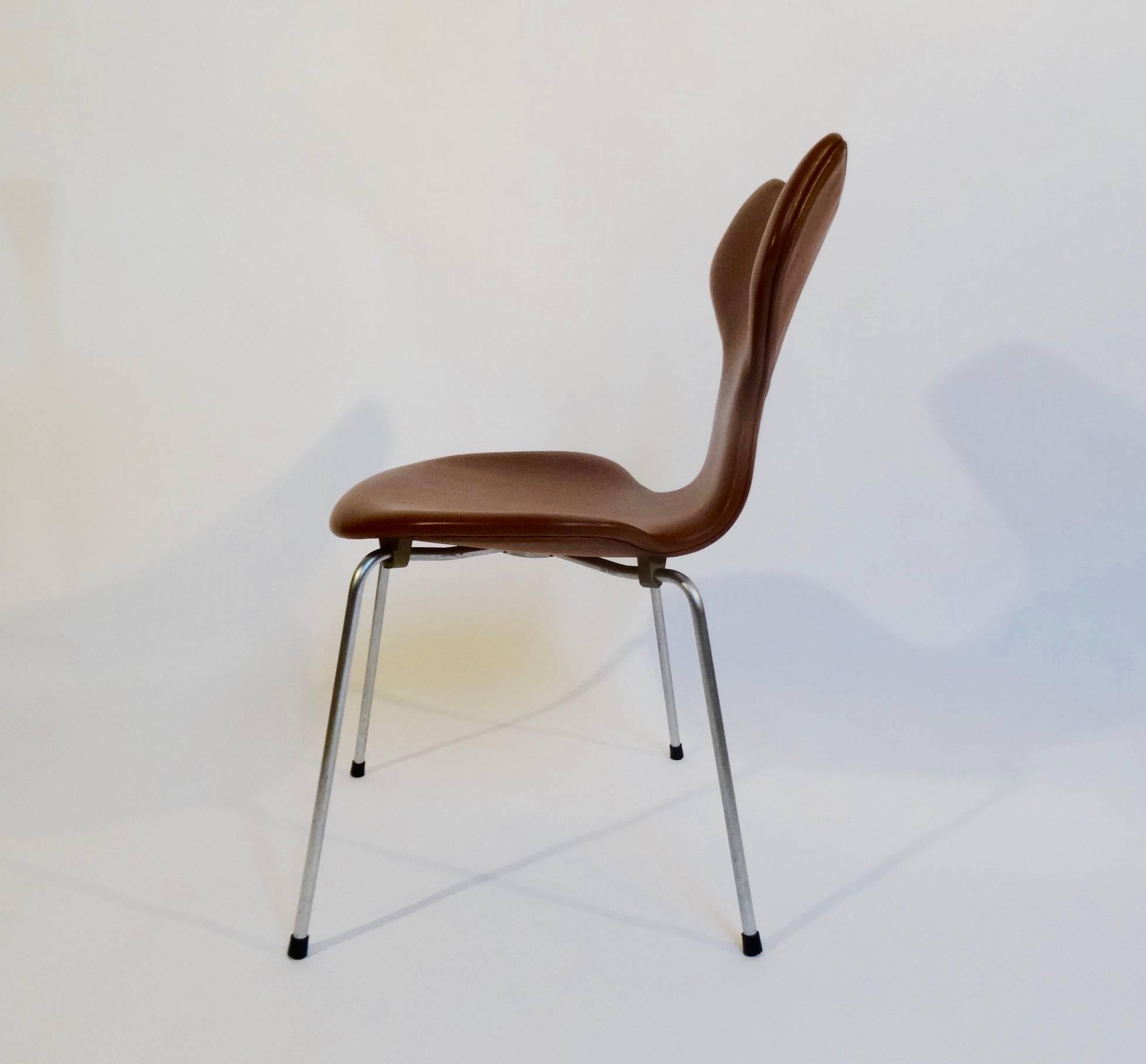 The iconic Grand Prix chair (3130) was introduced by Arne Jacobsen in 1957. This chair was manufactured in October 1964. Re-upholstered with high quality cognac colored anilin leather.