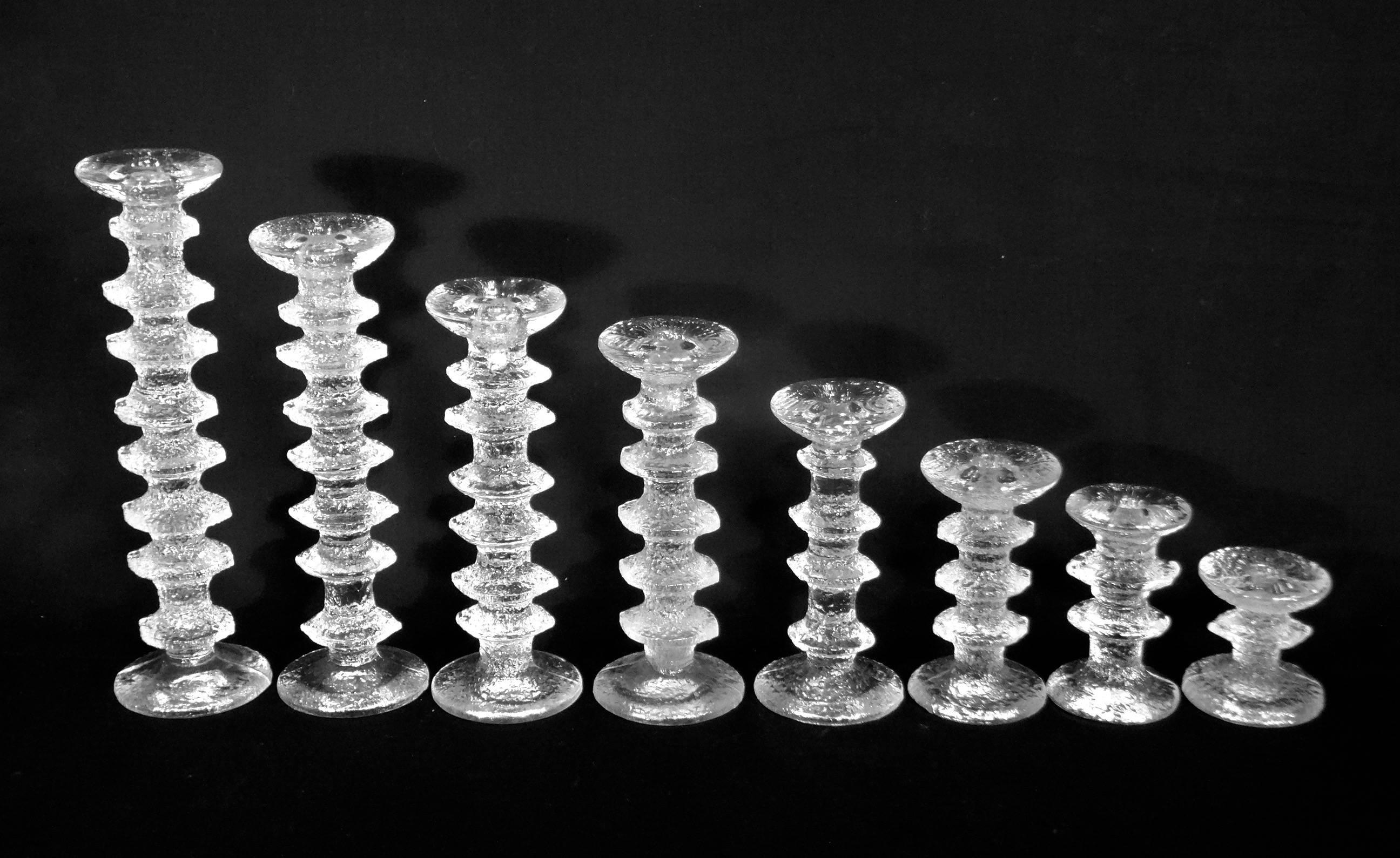 Complete set of eight Festivo candlesticks designed by Timo Sarpaneva for Iittala in 1966. Measures: Height from 8 to 31.5 cm.