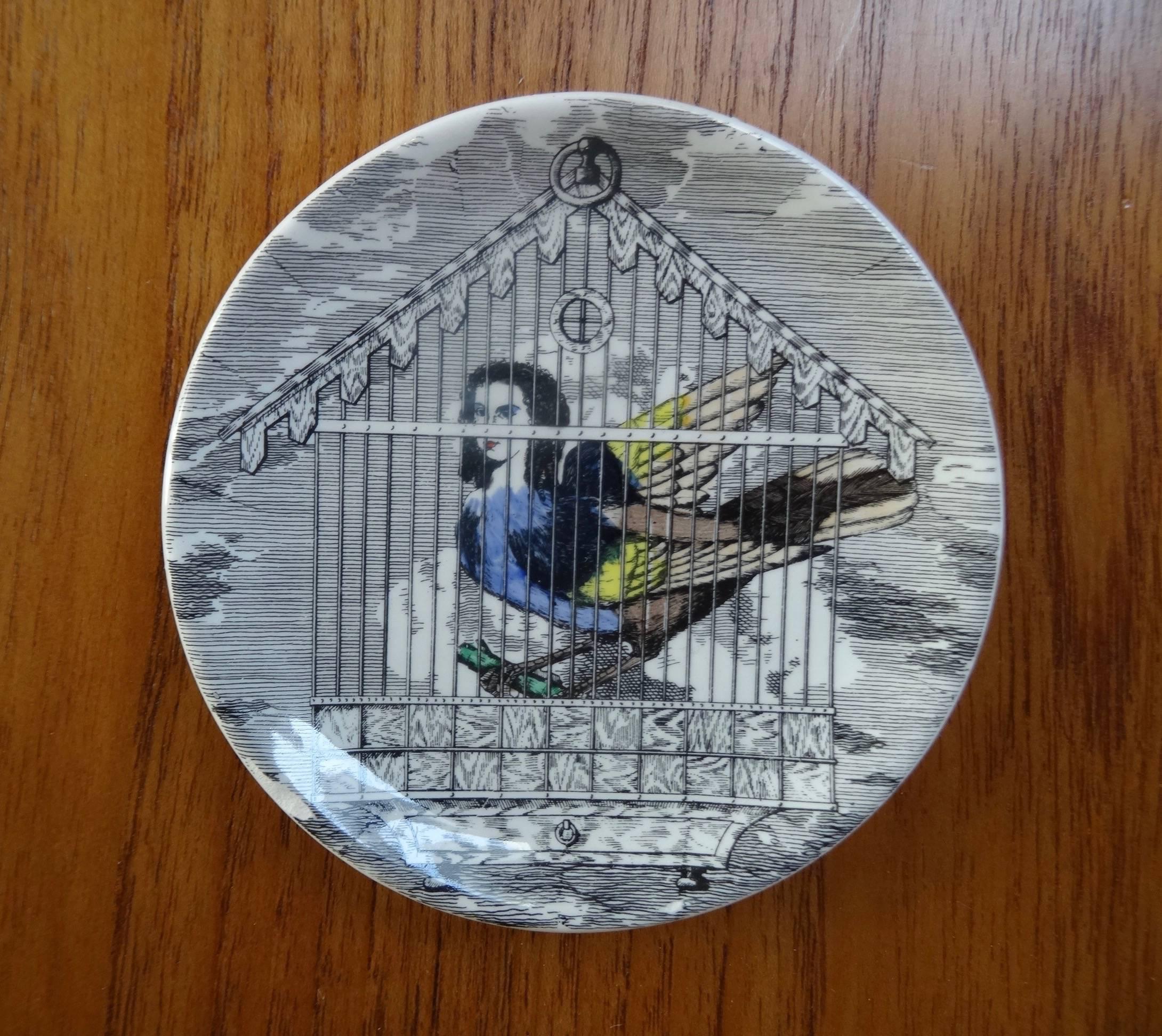 A complete set of the Le Arpie coasters. They are in mint condition and with the original box. Depicting Italian opera singers as harpies inside gilded boxes it is a sought after motive from Fornasetti´s imaginative design.