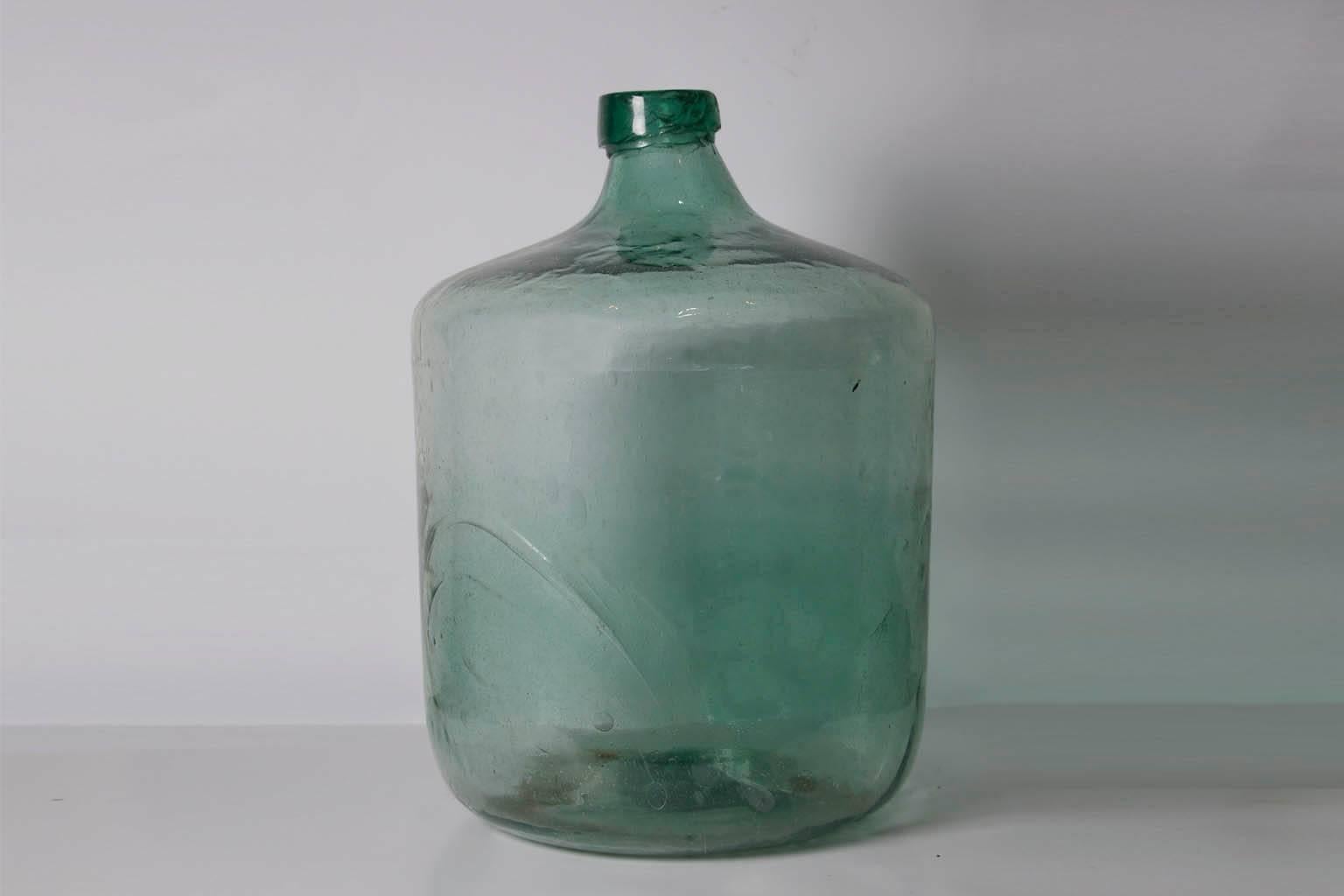 This 20th century (1930-1940) green handblown glass Demijohn from the state of Oaxaca Mexico was used to store Mezcal.
Excellent conditions can carry up to 50 liters.