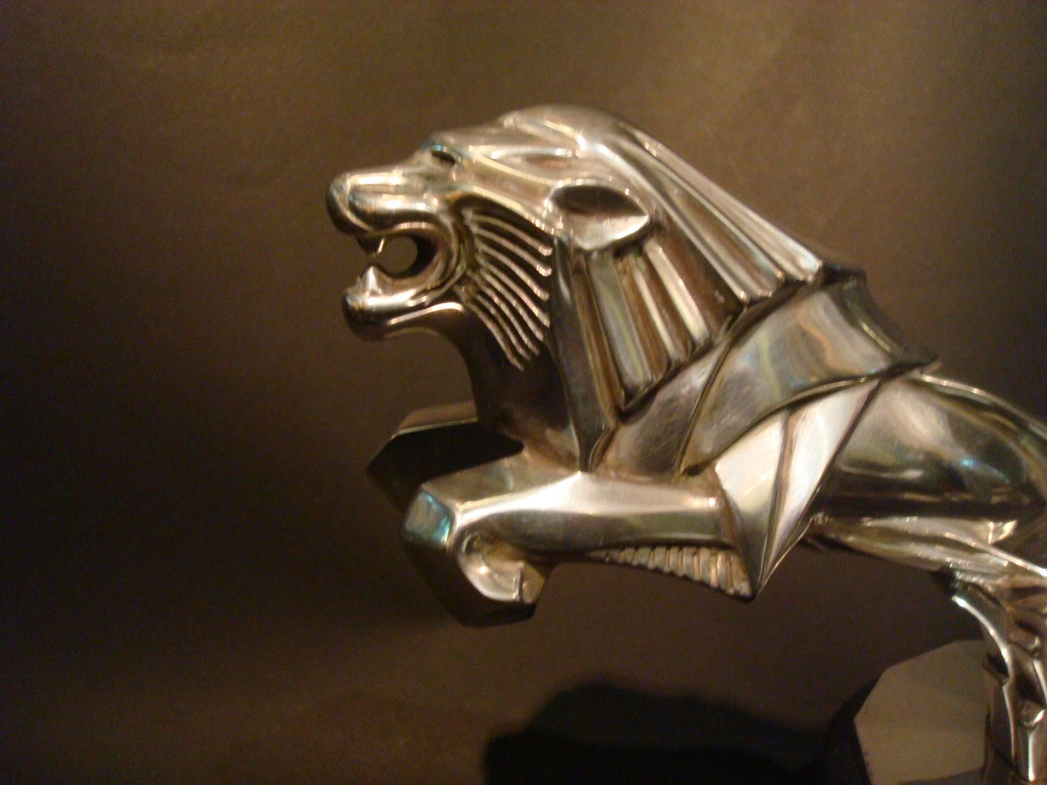 Rare Art Deco lion car mascot - hood ornament , automobilia. Silver plated bronze signed Jacques Cartier. Made in France, circa 1925.
Lovely lion mounted over a car radiator cap and over a wooden black base.