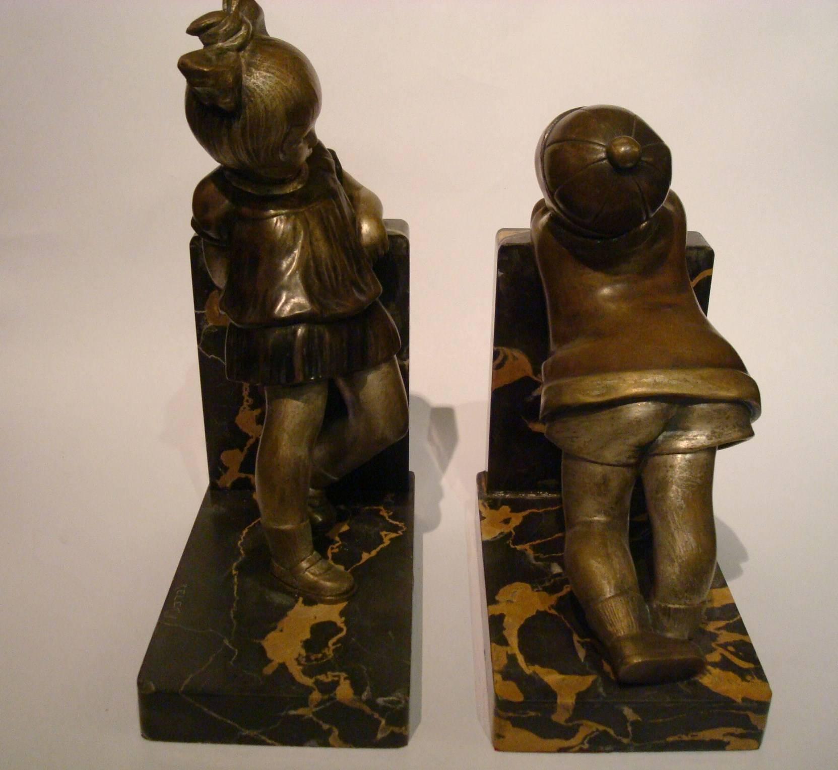 A very rare and superb bronze Art Deco bookends by Alexandre Kelety, circa 1930.

A nice original polychrom patina, on a Portor marble base. These bookends are of a remarkable quality of execution.

Art Deco and other figures