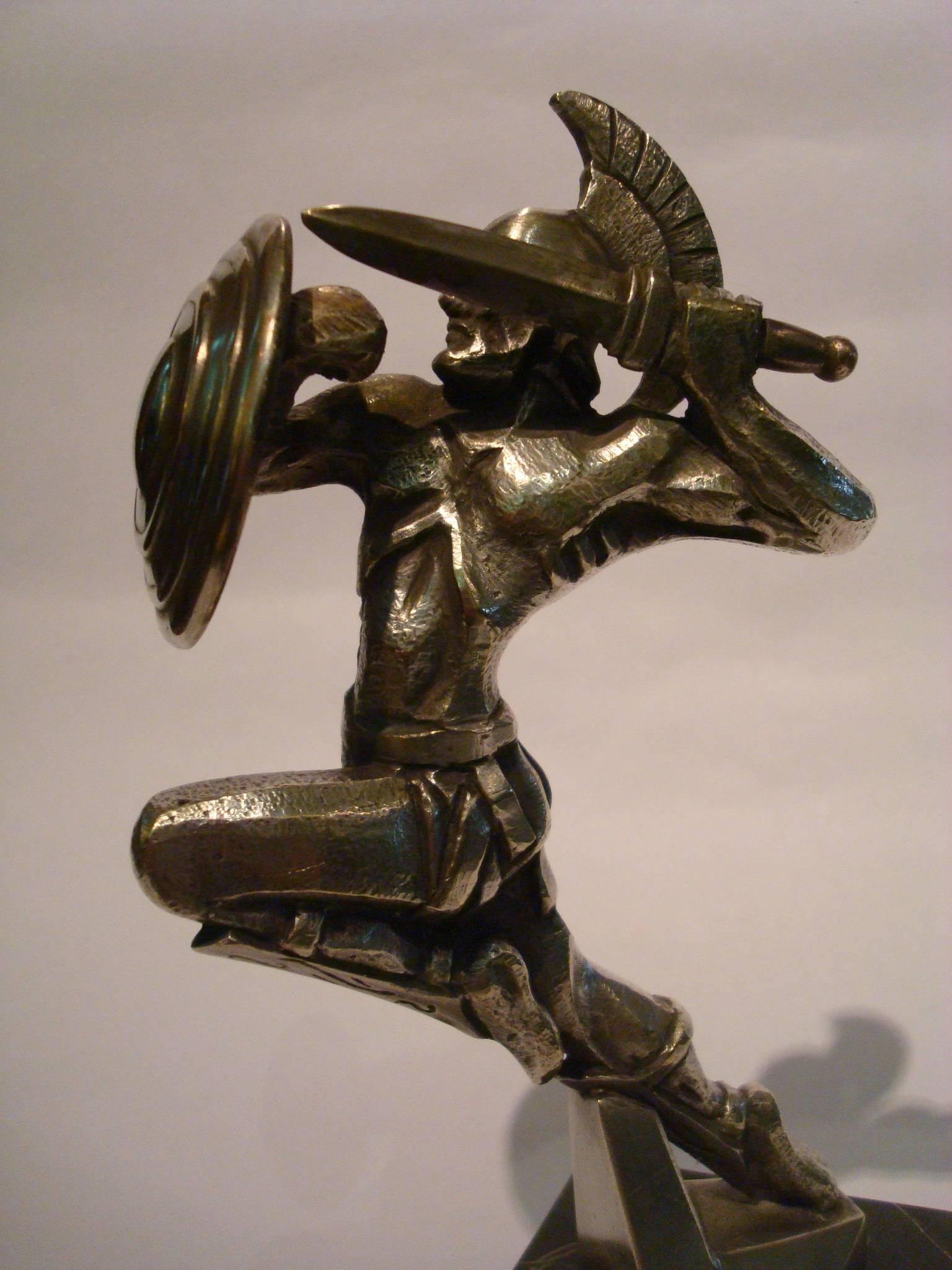 Fantastic Art Deco Gladiator car mascot. Signed R. Varnier. 
Varnier was the sculptor, M. Bonnot the editer. This piece was also distributed by Marvel. Made in France 1920-1925.
Made of bronze. Mounted over a marble base. You can find a similar