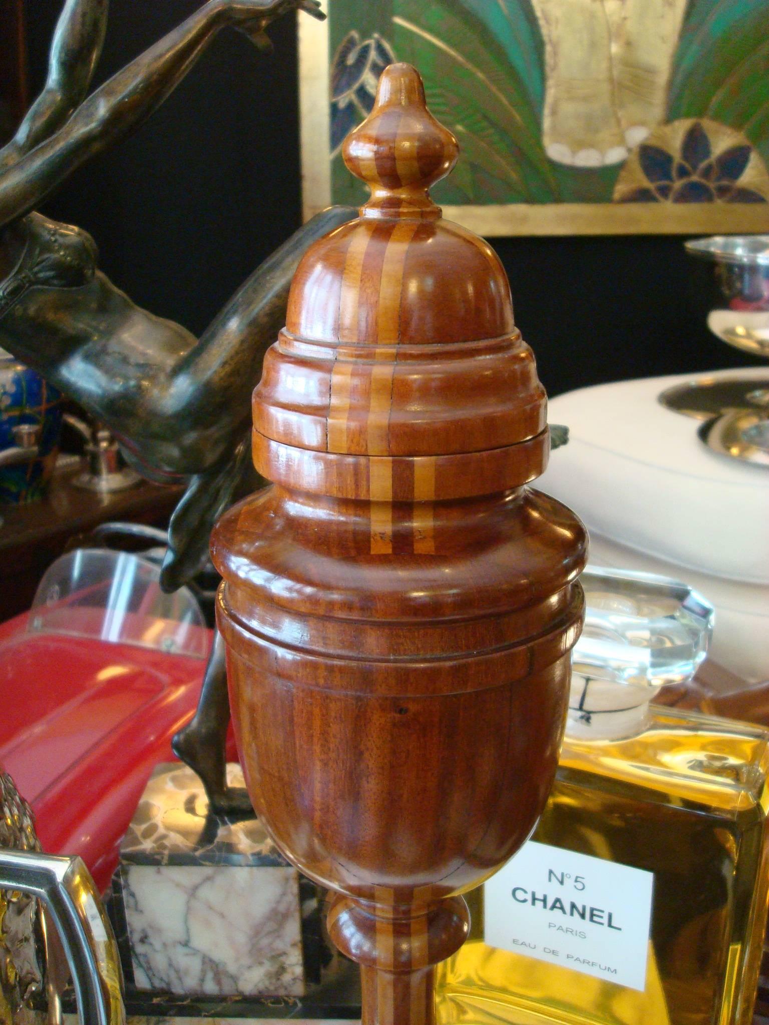 Very nice giant Bishop chess piece. Made of several woods following a pattern. The top comes off, and it has something like an urn, maybe a secret hidden place.

Chess is a two-player strategy board game played on a chessboard, a checkered