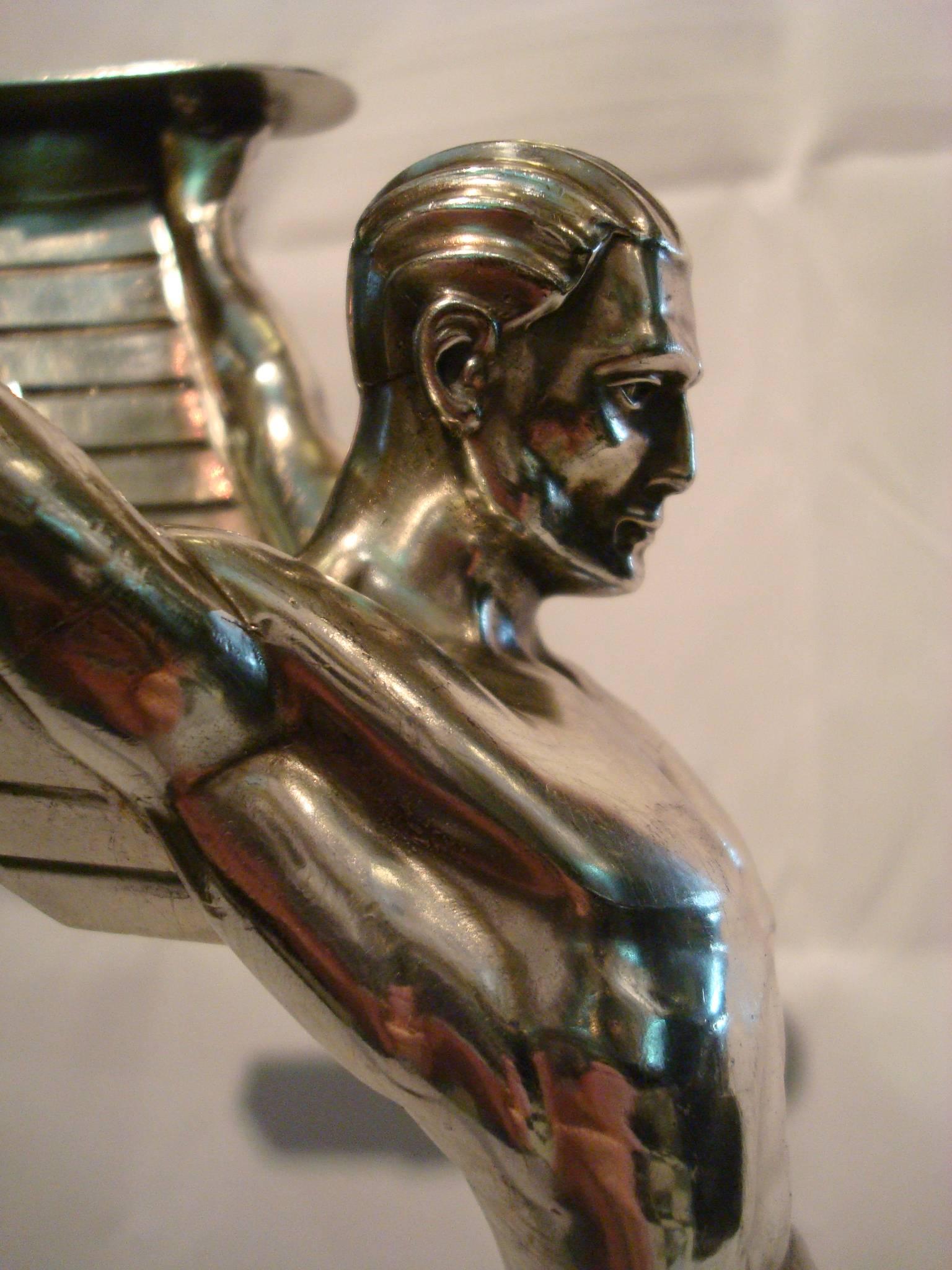 Icarus. Often related to Airplanes and Aviation items. 
Art Deco metal sculpture of an athletic nude man with stylized wings.
Attributed to Otto Schmidt Hofer.

In Greek mythology, Icarus is the son of the master craftsman Daedalus, the creator