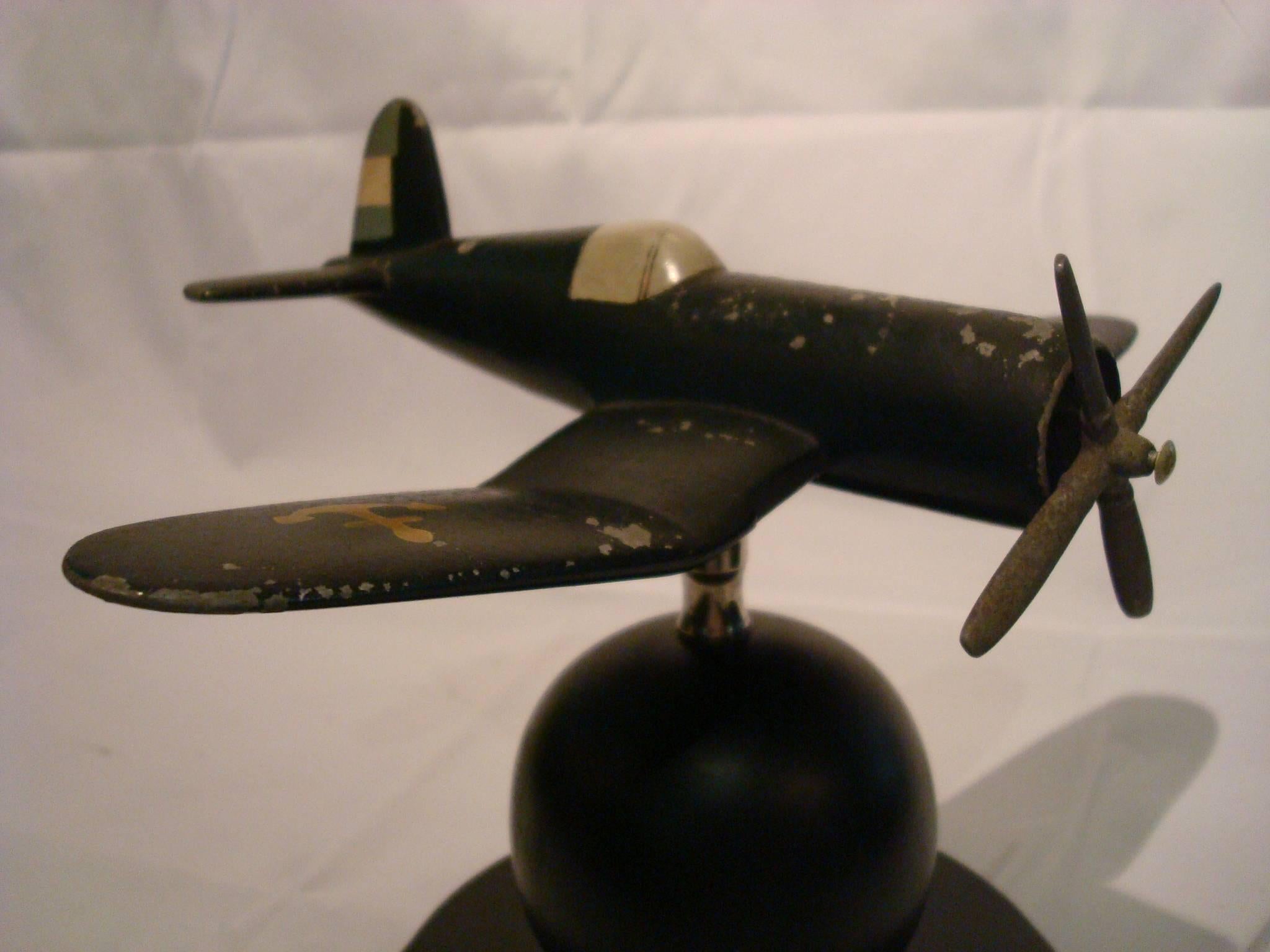 Art Deco airplane desk model Vought F4U Corsair, 1940s. The airplane has movement, can be regulated in many positions. The wooden base has been repolished. The airplane is in original conditions, with time wear.

The Vought F4U Corsair is an