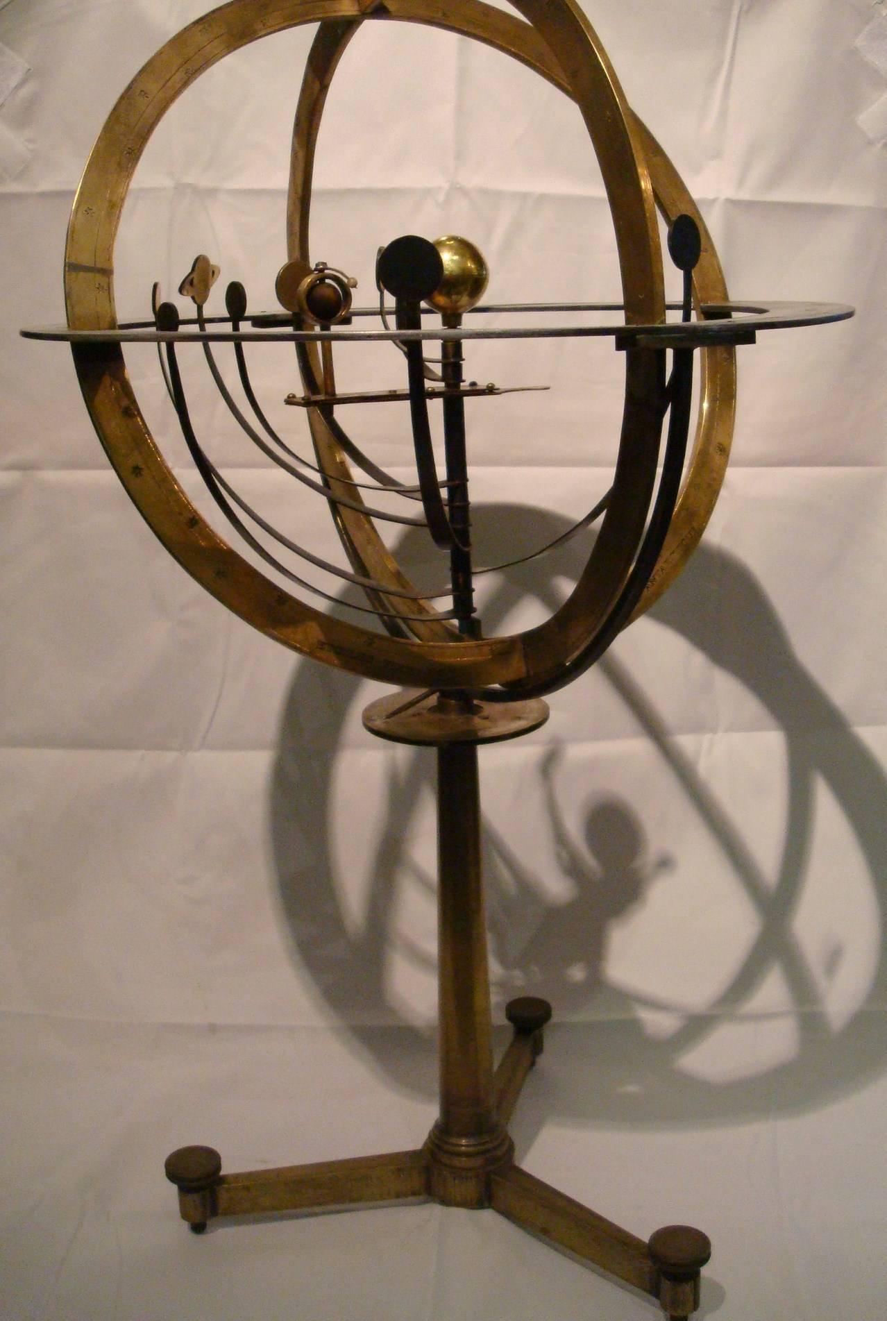 A brass Armillary Sphere. An Attractive Armillary sphere. The sphere with aluminium horizon circle divided in four quadrants with zodiac and calendar scales, the brass vertical circle and ecliptic rules and punched with stars, in the centre a