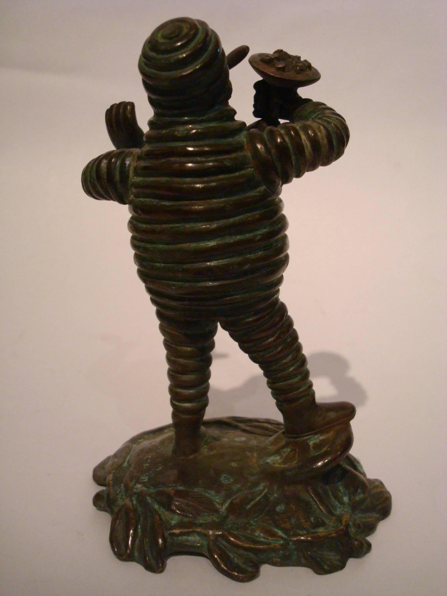 Fantastic Michelin Man ¨Bibendum¨ advertising Car Mascot, Hood Ornament. Excellent piece of automobilia. Original Patina. On the Book The Michelin Man by Rudy LeCoadic page 107, you can find pictures and information.
It says: Car Mascot signed C.
