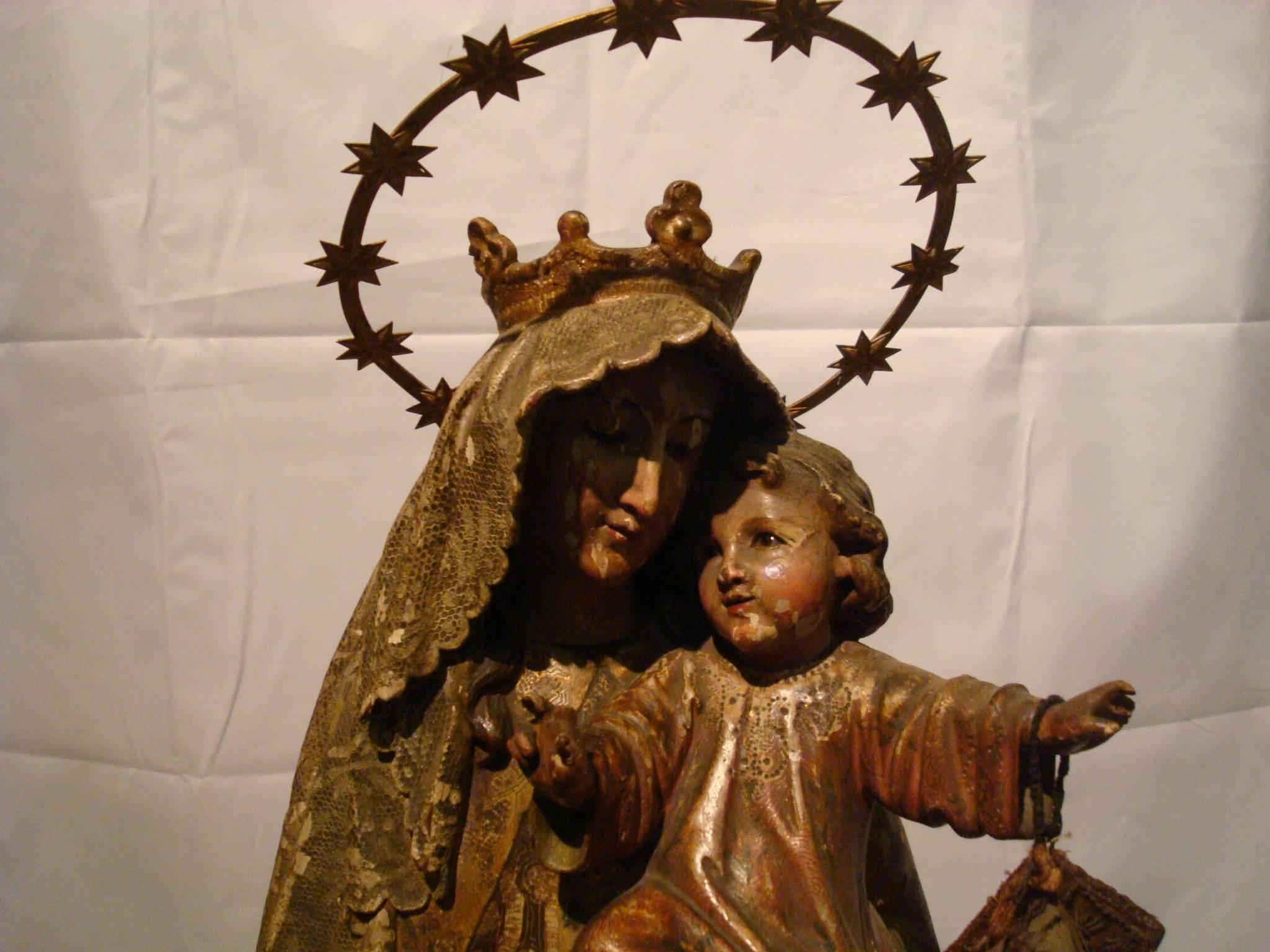 19th century wooden sculpture of The Crowned Virgin - wood carved polychrome figure of Virgin Mary - Madonna and Jesus Child from Spain. Catholic.
The hand-carved wooden figure is a typical Spanish depiction of Mary with the Infant Jesus. She is