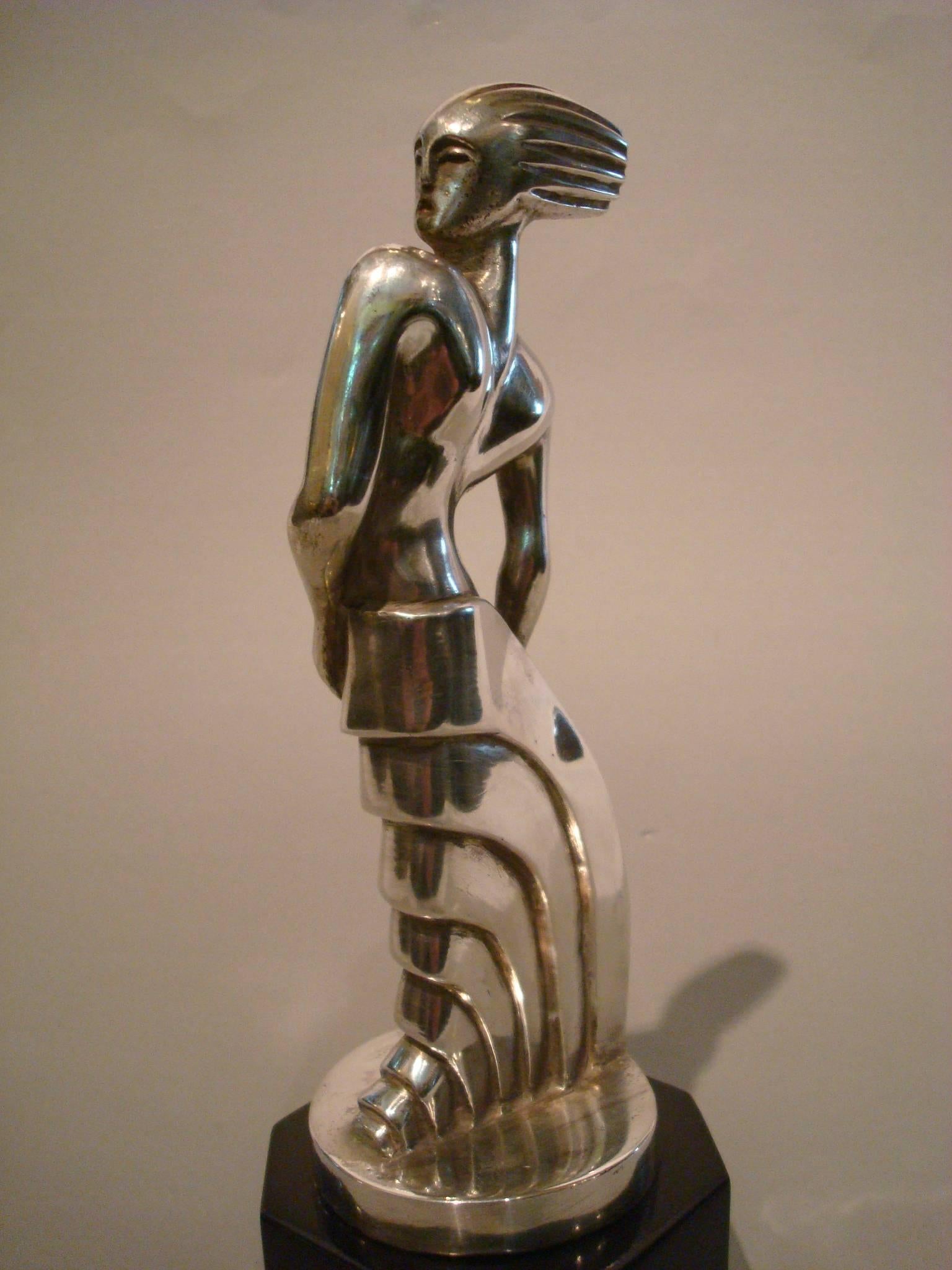 Art Deco silvered bronze sculpture standing woman by S. Rueff, France, 1925.
Stylized Art Deco woman. Rare car mascot hood ornament. Can be also be used as paperweight. Stylized Art Deco woman, silver-plated bronze, black polished wooden base.