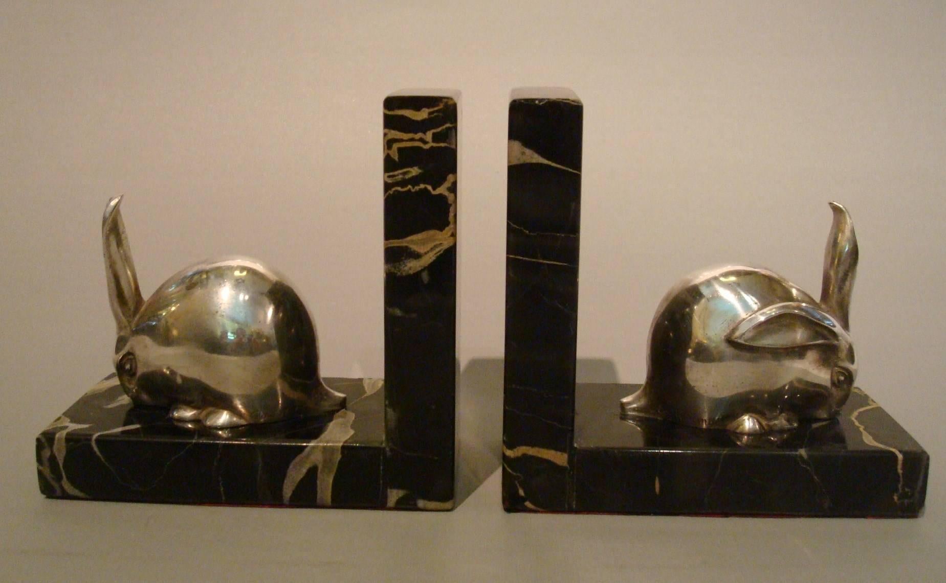 Art Deco silvered bronze rabbit, hare sculpture bookends - Edouard-Marcel Sandoz. Mounted over black portoro marble bases.

Edouard-Marcel Sandoz (1881-1971)
Born in Basle, educated in Switzerland, Edouard Marcel Sandoz worked mainly in Paris,