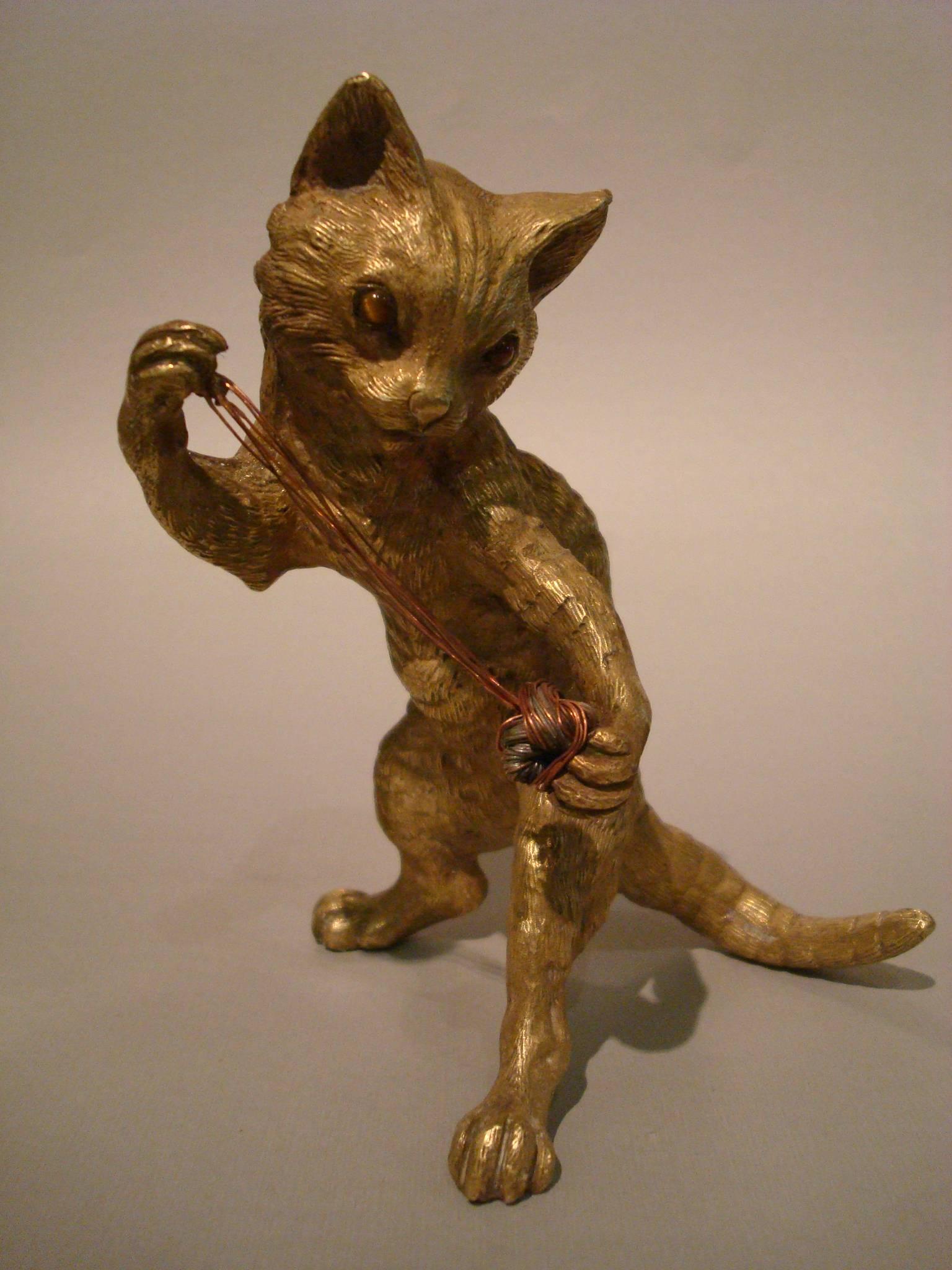 Very detailed Vienna gilt bronze figure of a playing cat.
The cat has stone eyes.