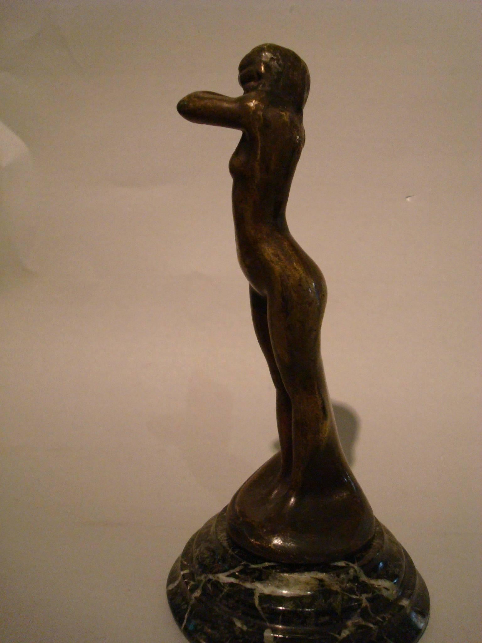 Lovely Art Deco shy naked women made of bronze and mounted over a green marble base. It is signed L. Betti and foundry Etling Paris. Perfect piece of Automobilia - paperweight - car mascot - hood ornament. Figure measures 15.5 cm high plus the base.