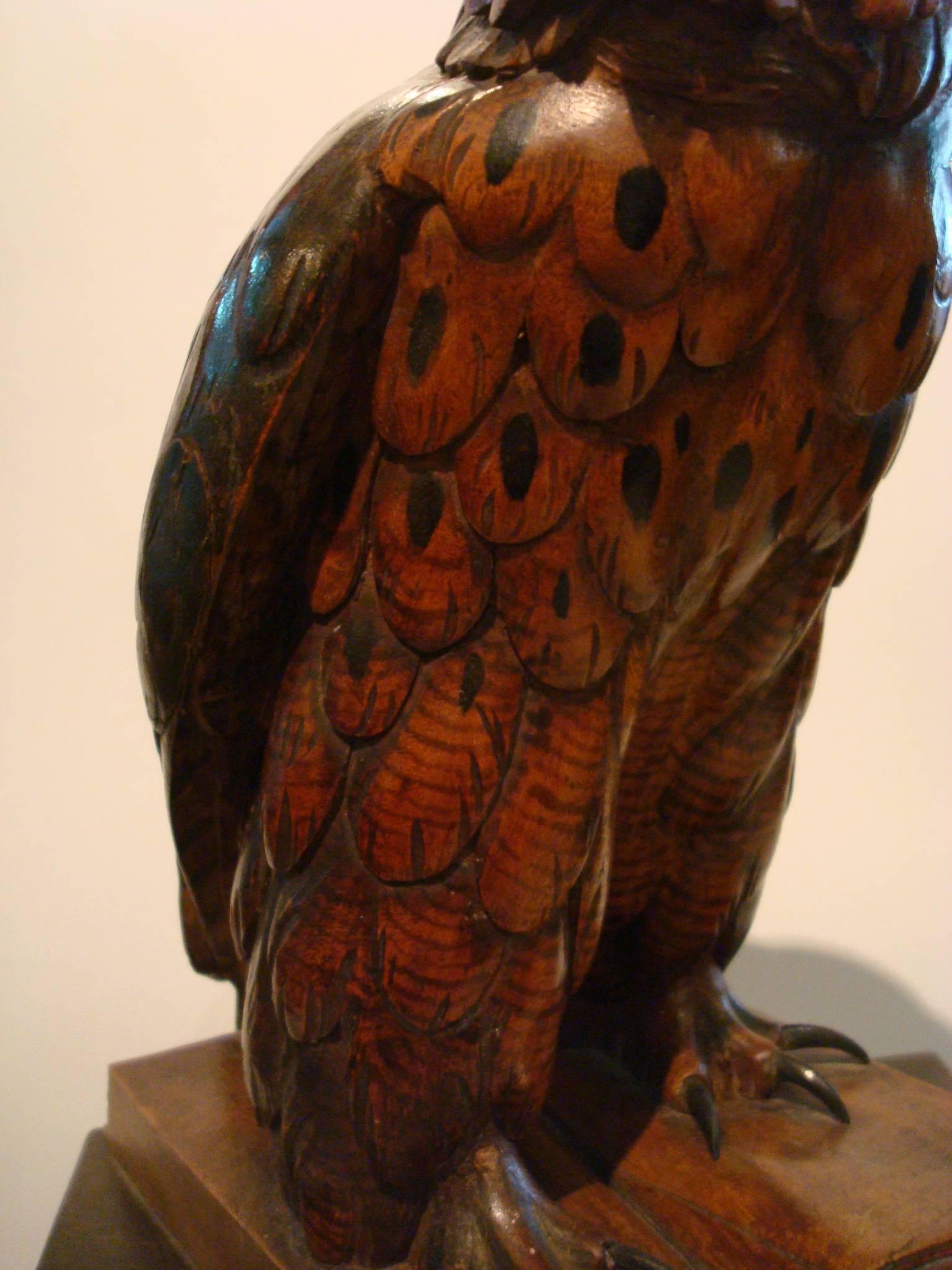 Fantastic large wooden carved owl over books. It has glass eyes, one of them has an internal chip or a slight defect that can be seen in the pictures. A carved Black Forest antique owl of exceptional size.