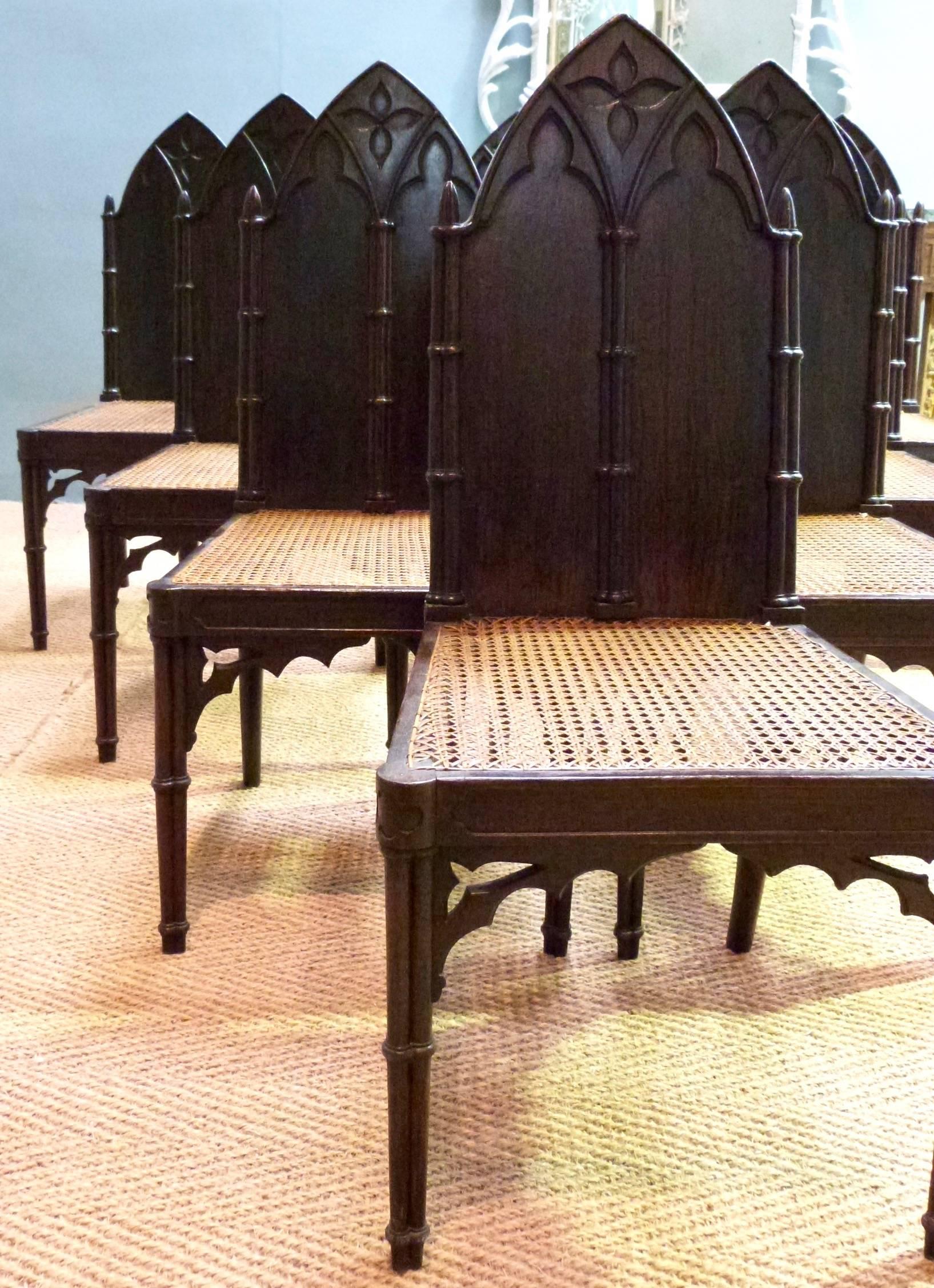 A set of eight Regency faux rosewood hall chairs in the Gothic style.
 