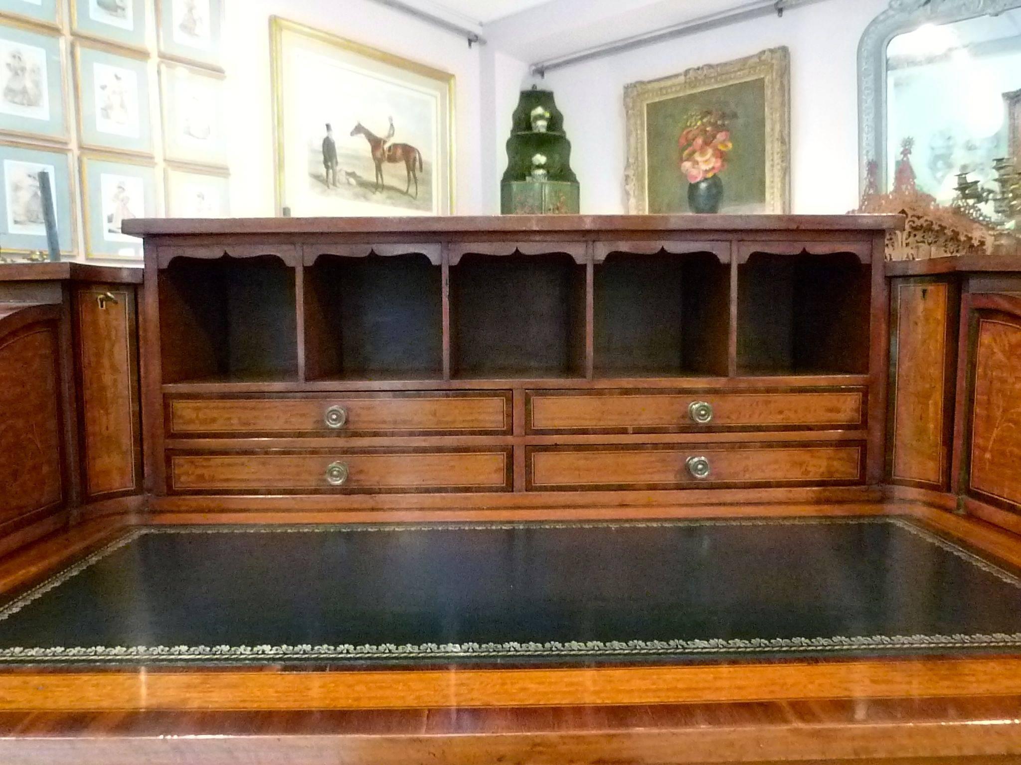 A fine quality late 19th century satinwood and rosewood banded Carlton House desk.